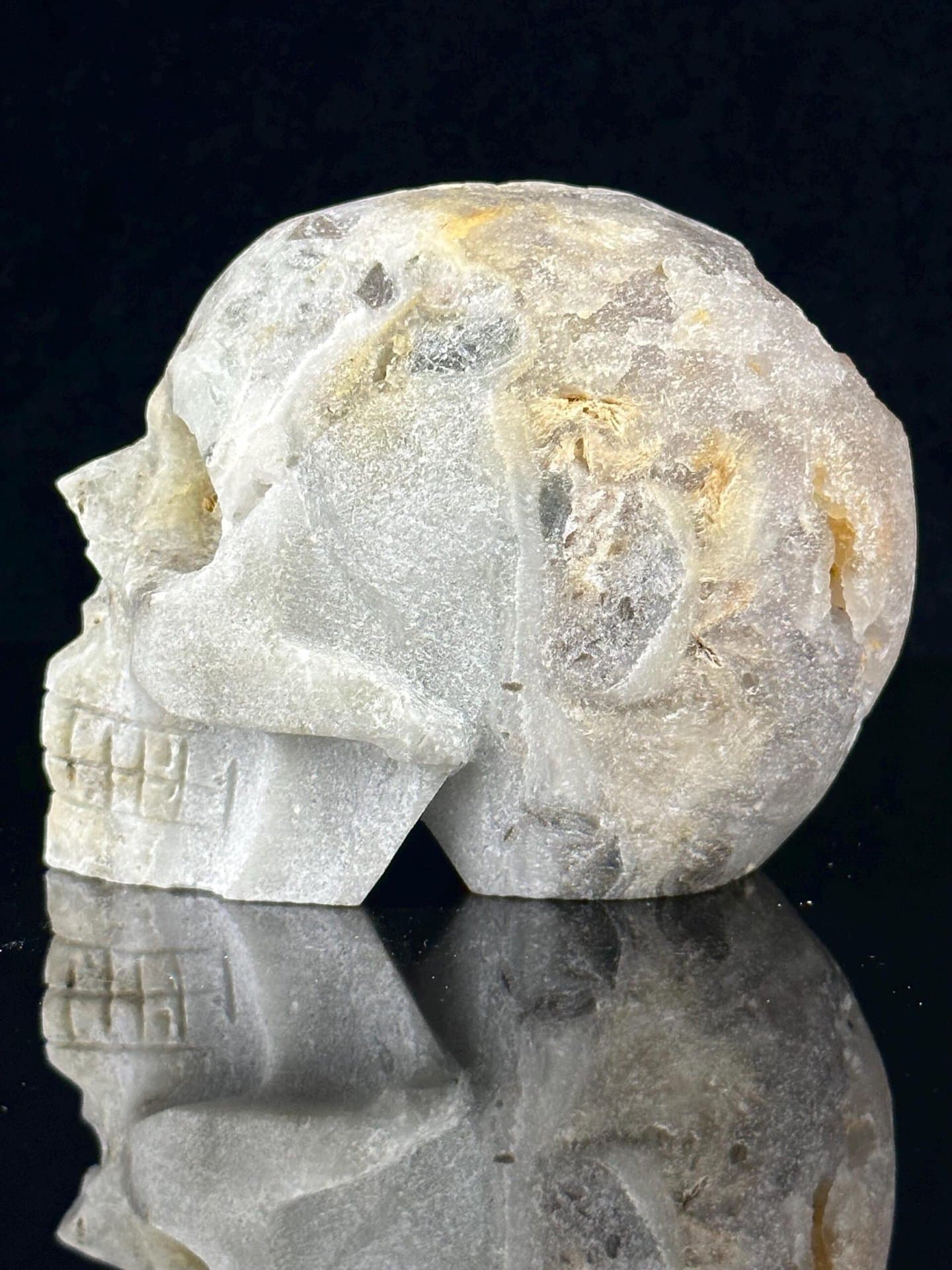 Detail of druzy quartz sparkle inside carved skull