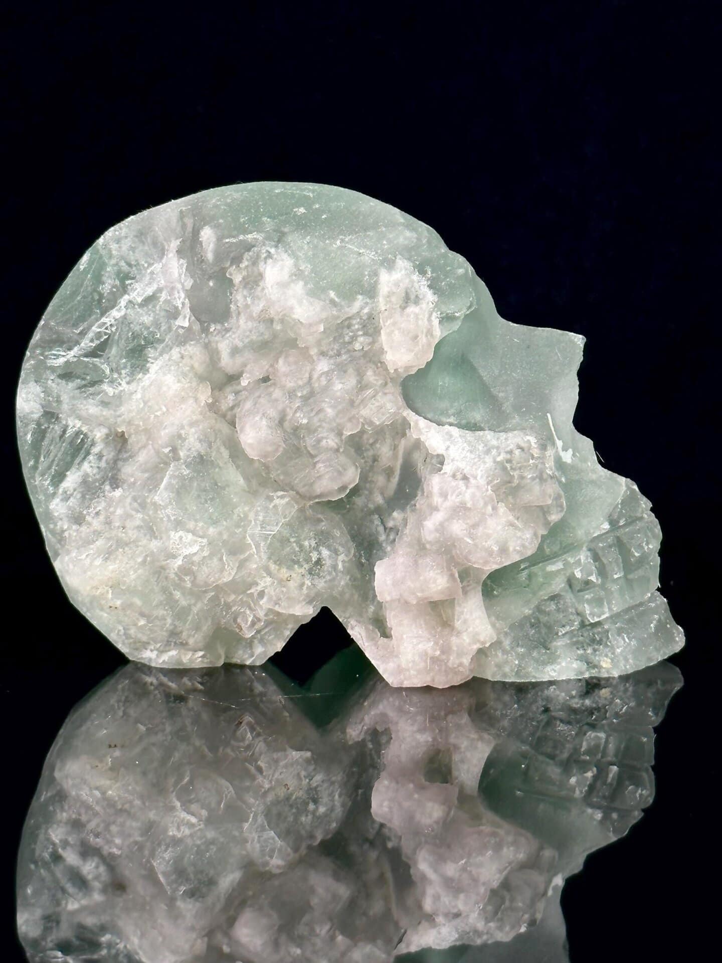Close-up of green fluorite carving detail on skull
