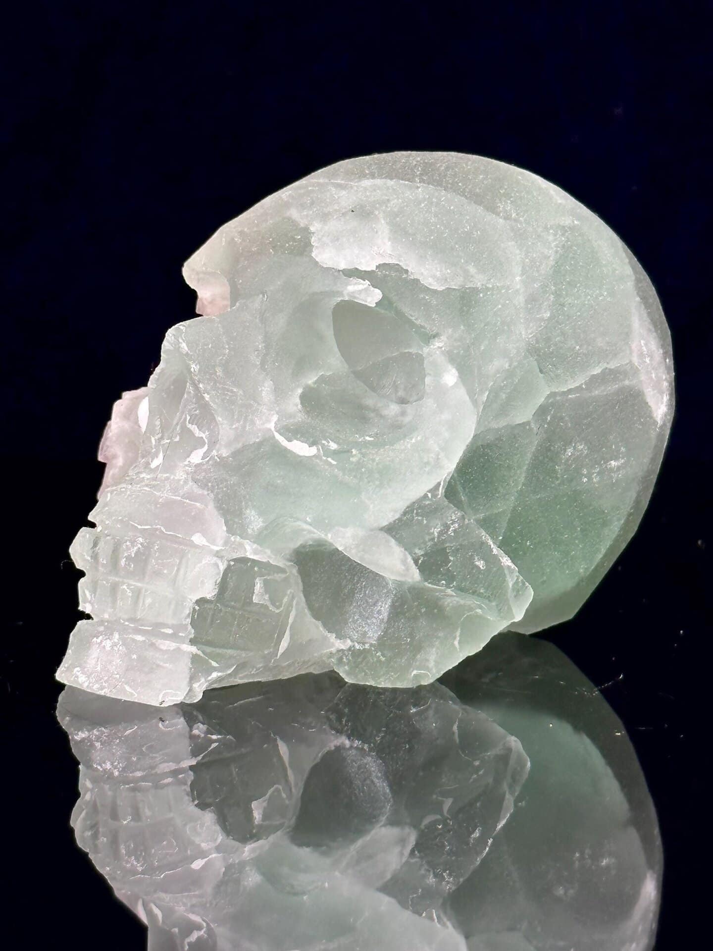 Detail of raw fluorite geode within carved skull
