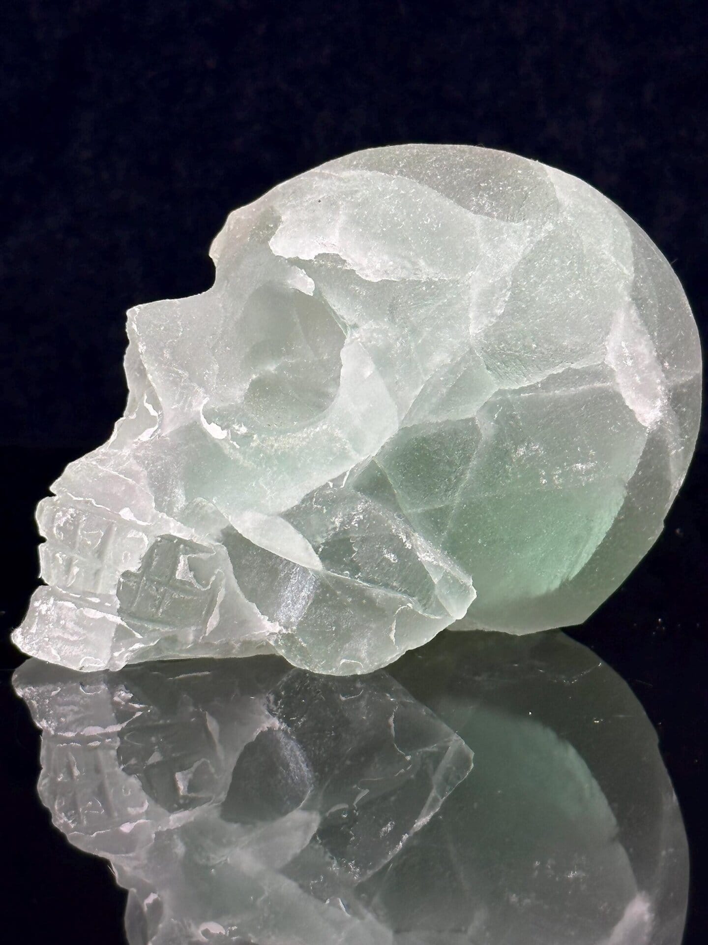 Large hand-carved green fluorite skull with geode interior