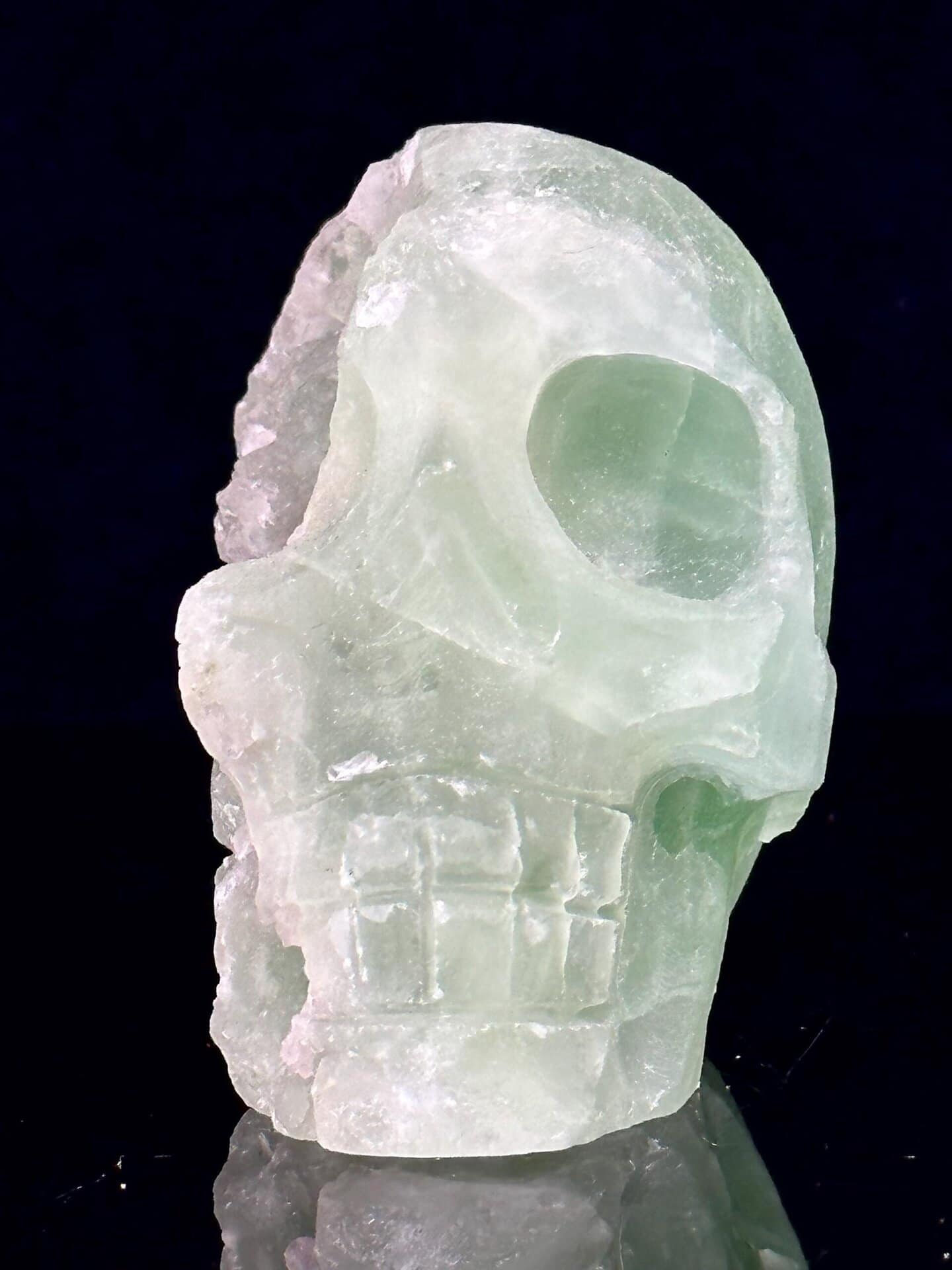 Front view of green fluorite skull showing carving detail