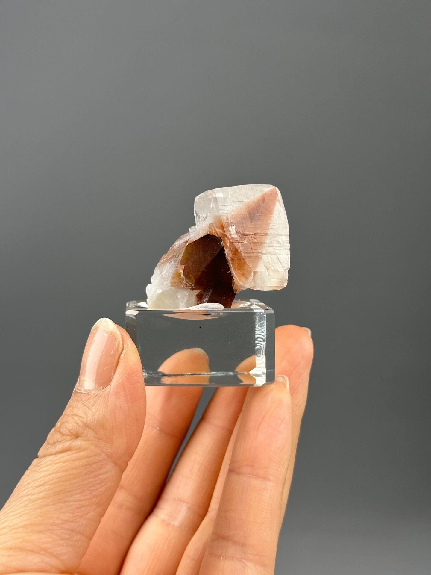 Angled view highlighting red hematite within calcite