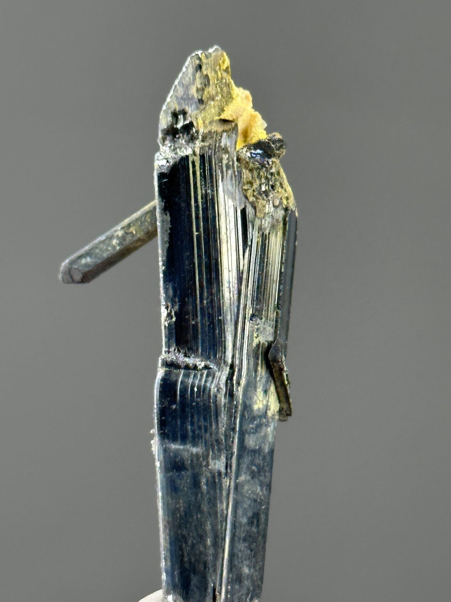 Angled view of stibnite crystal showing metallic brilliance
