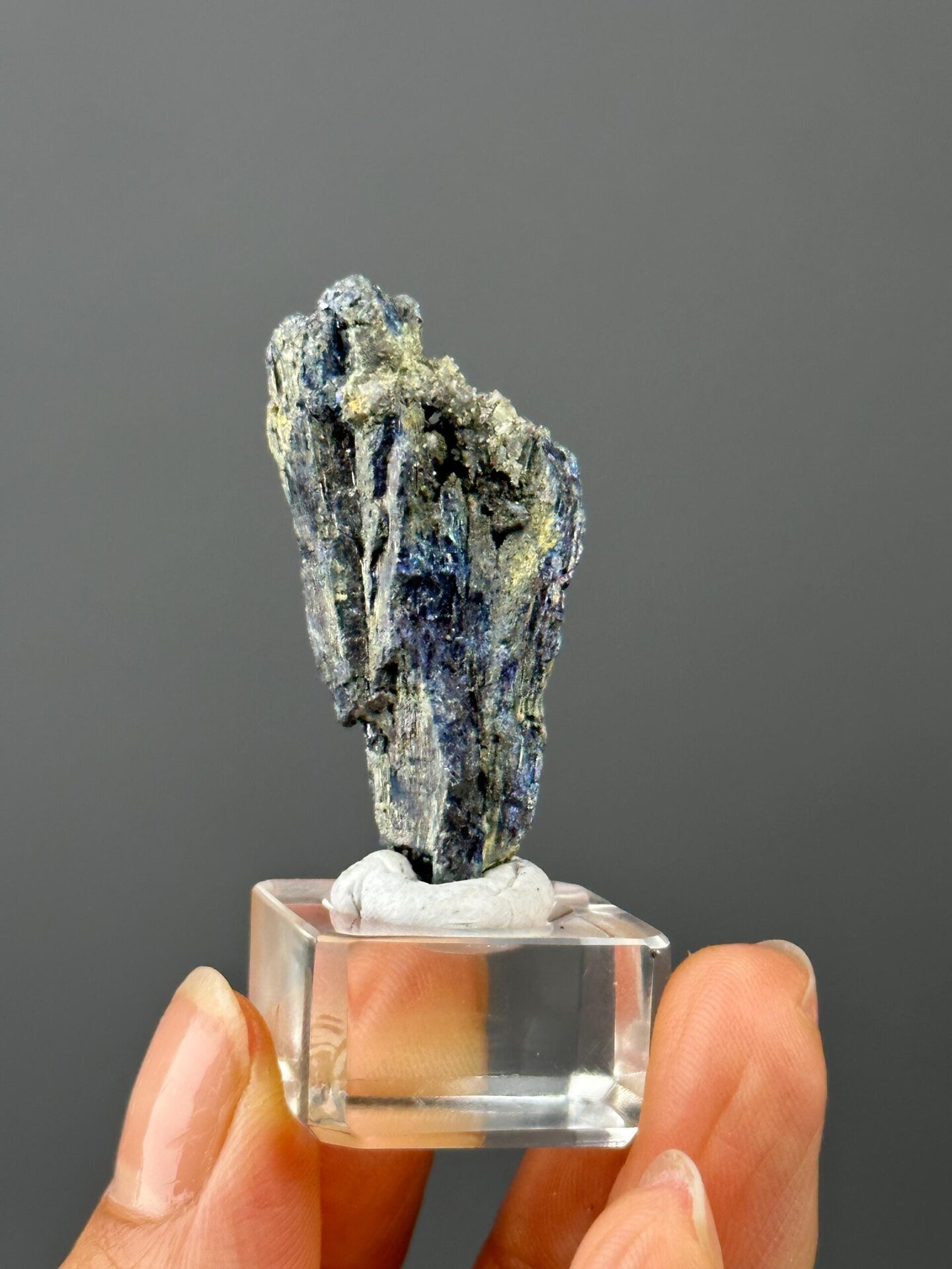 Front view of iridescent stibnite crystal, 1.8×0.6×0.7 in
