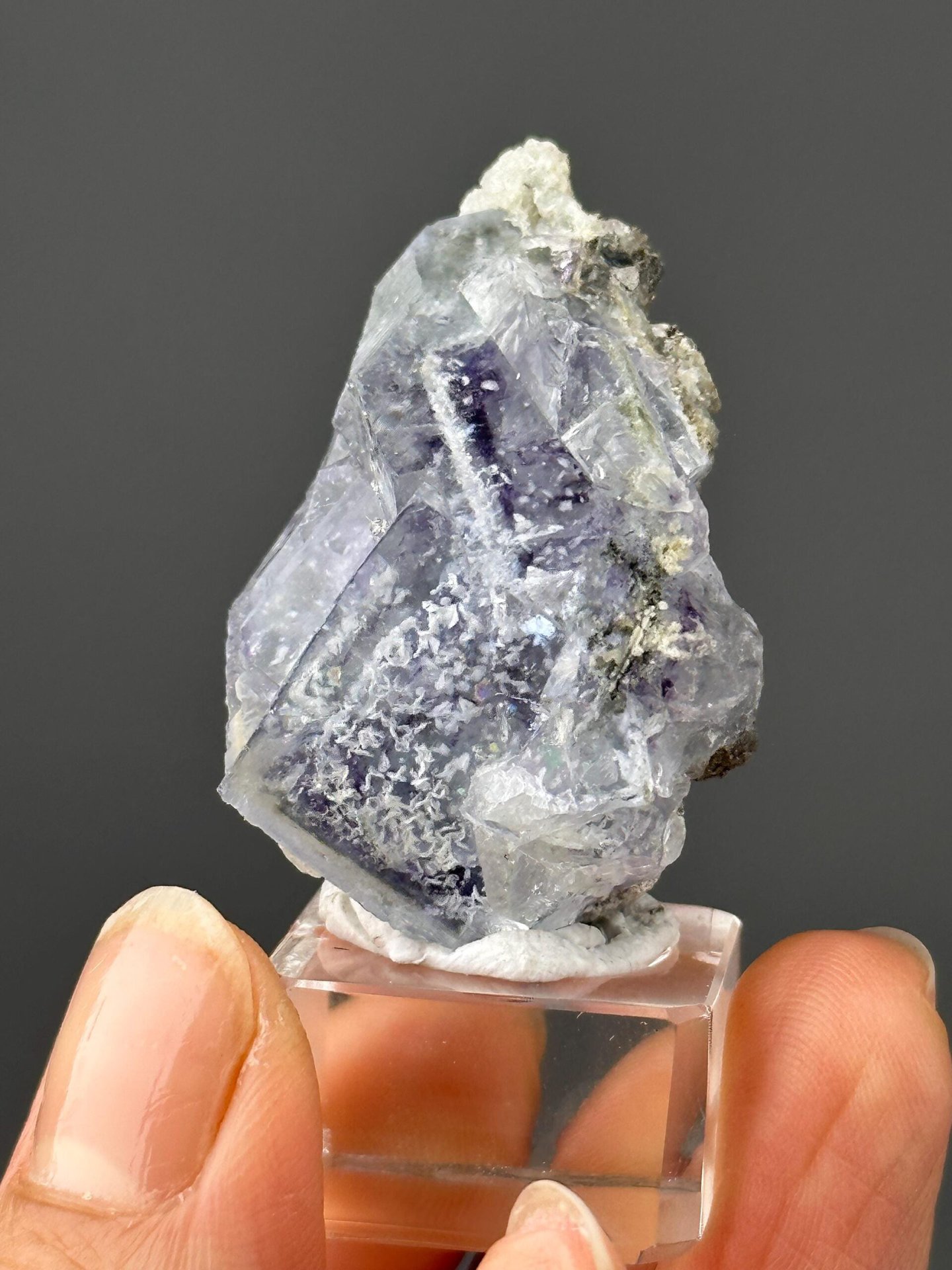 Close-up of snowflake inclusions within purple fluorite