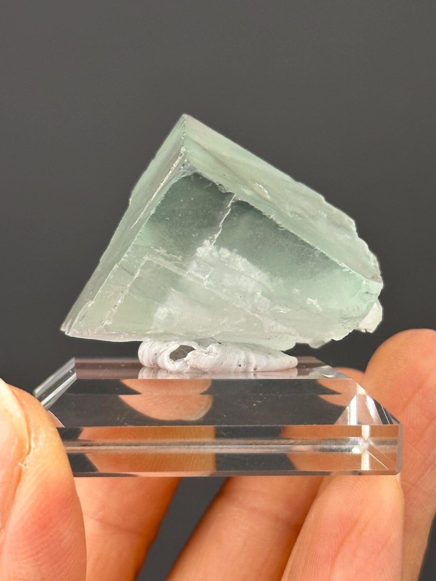 Side view of green fluorite cluster on matrix
