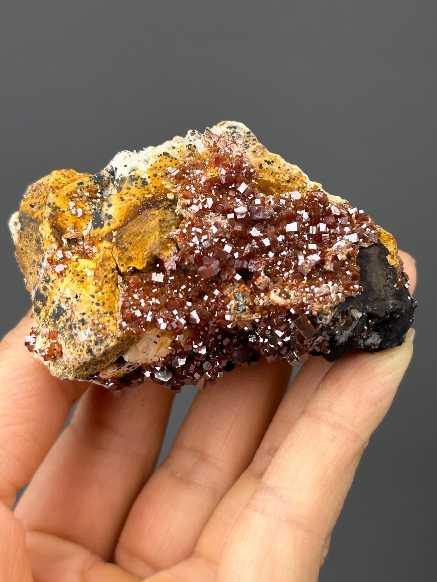 Front view showing vibrant red vanadinite hexagonal crystals