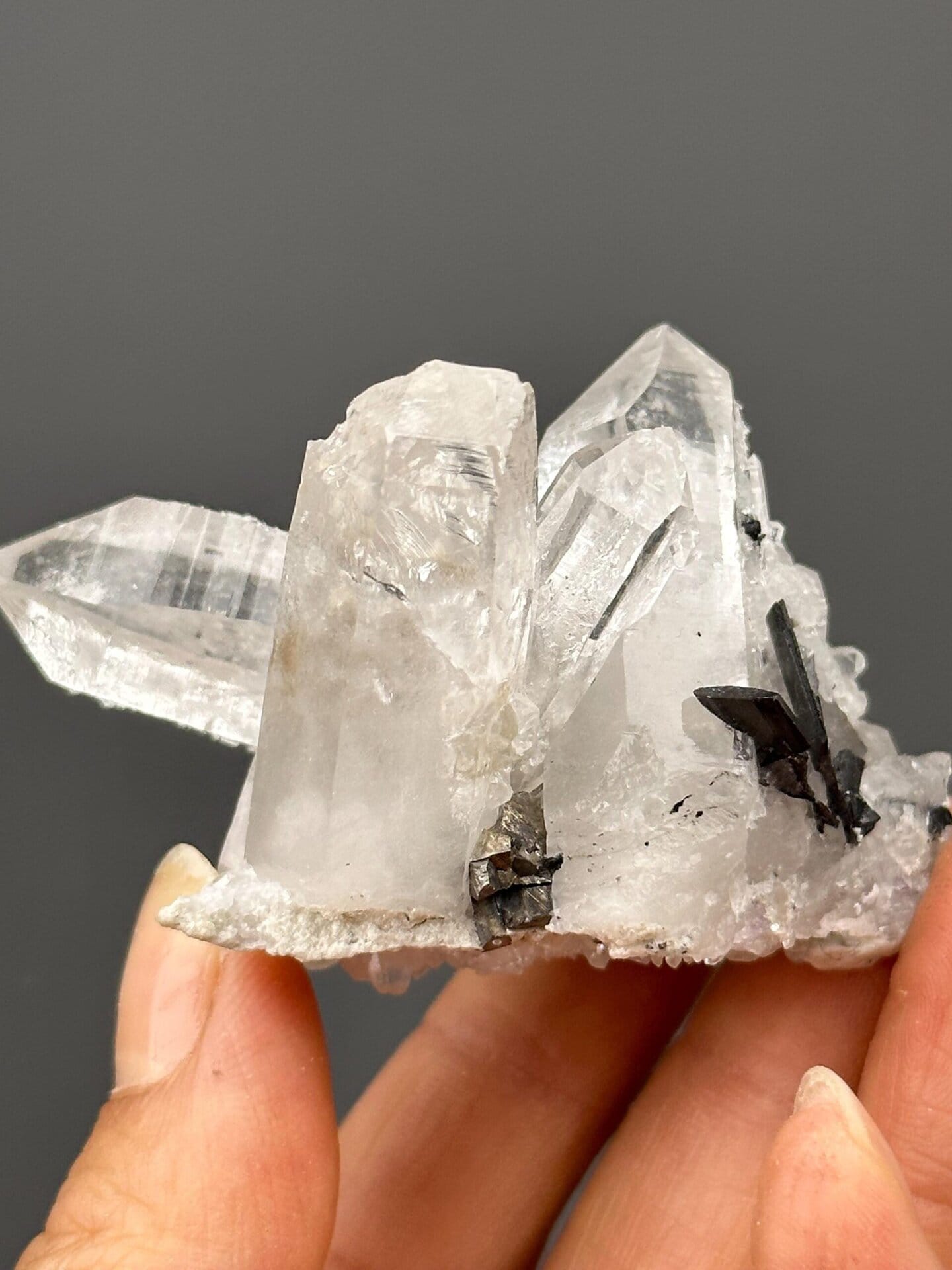 Close-up of quartz crystal faces with pyrite accent