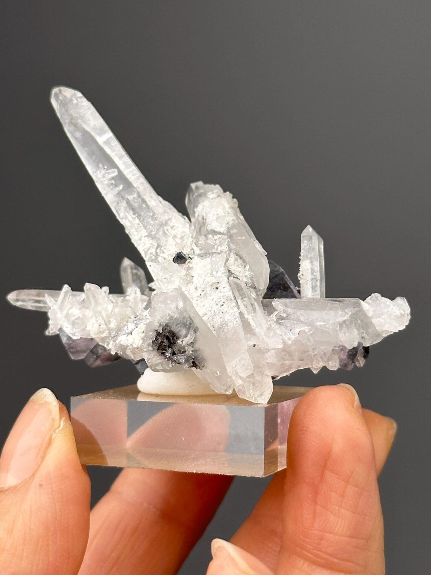 Close-up of purple fluorite with cassiterite and quartz