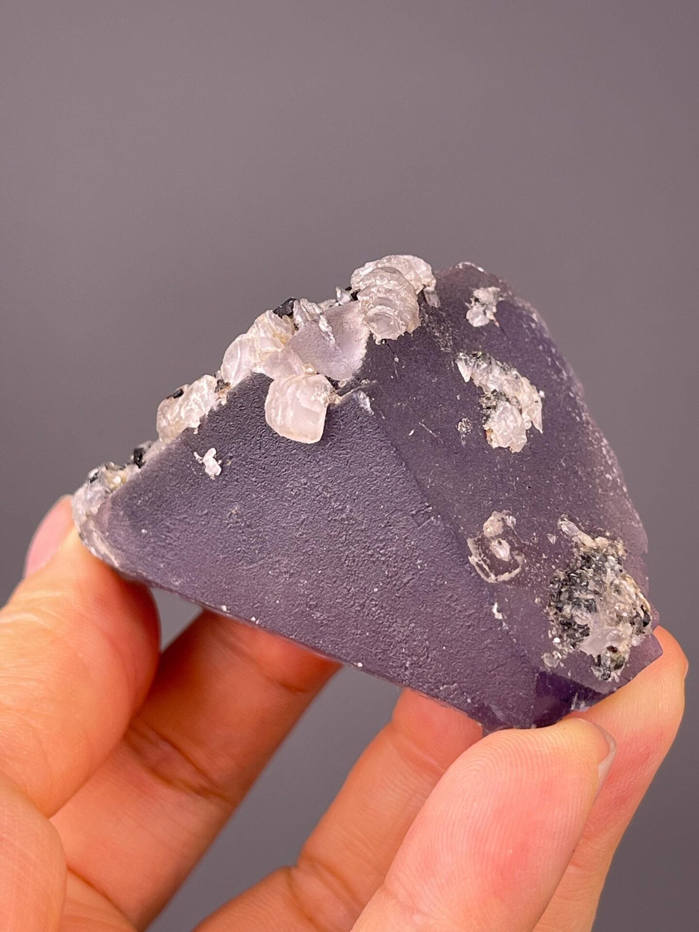Top view of triangular purple fluorite face with calcite
