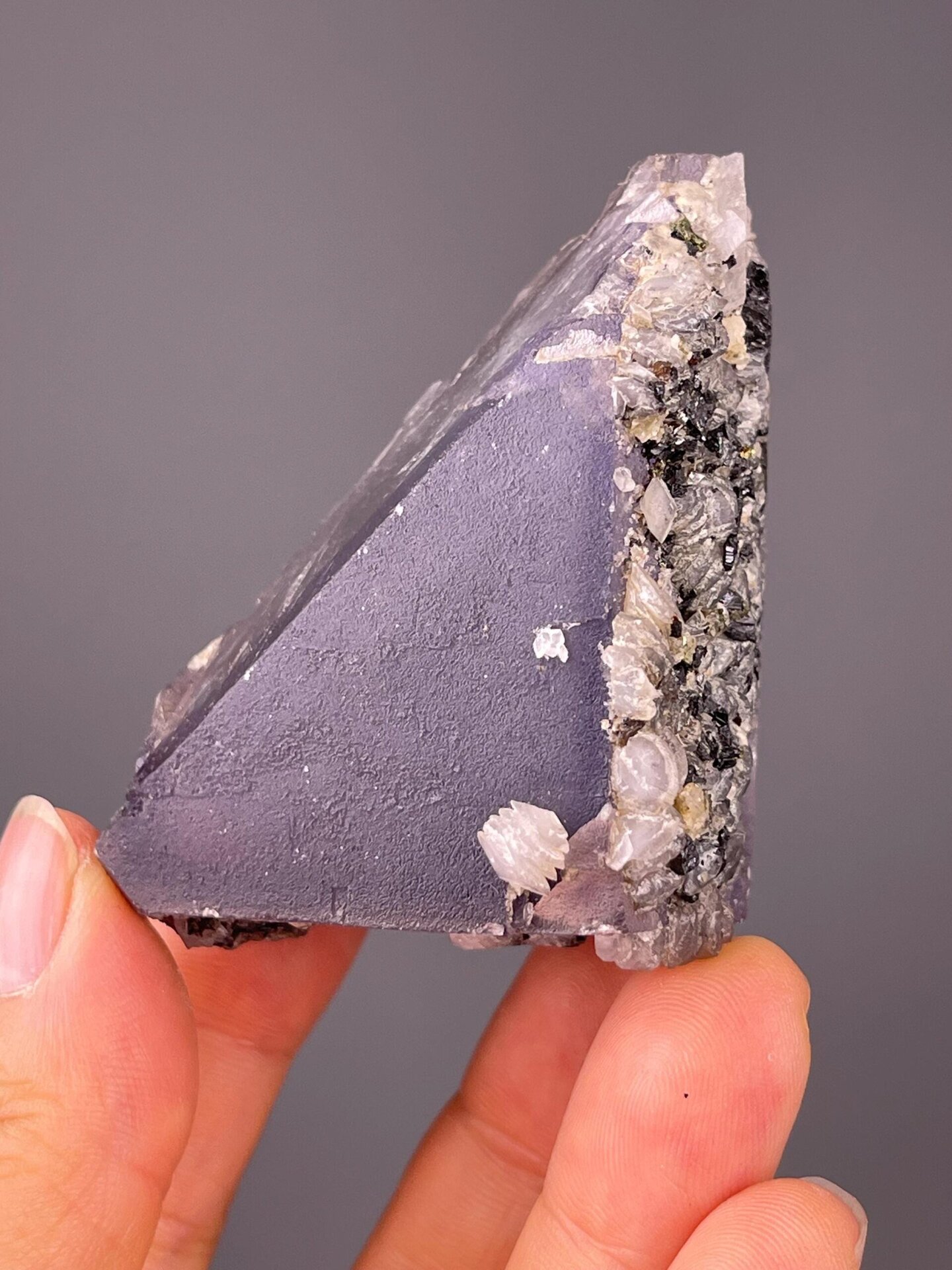 Purple fluorite triangle displaying vitreous luster