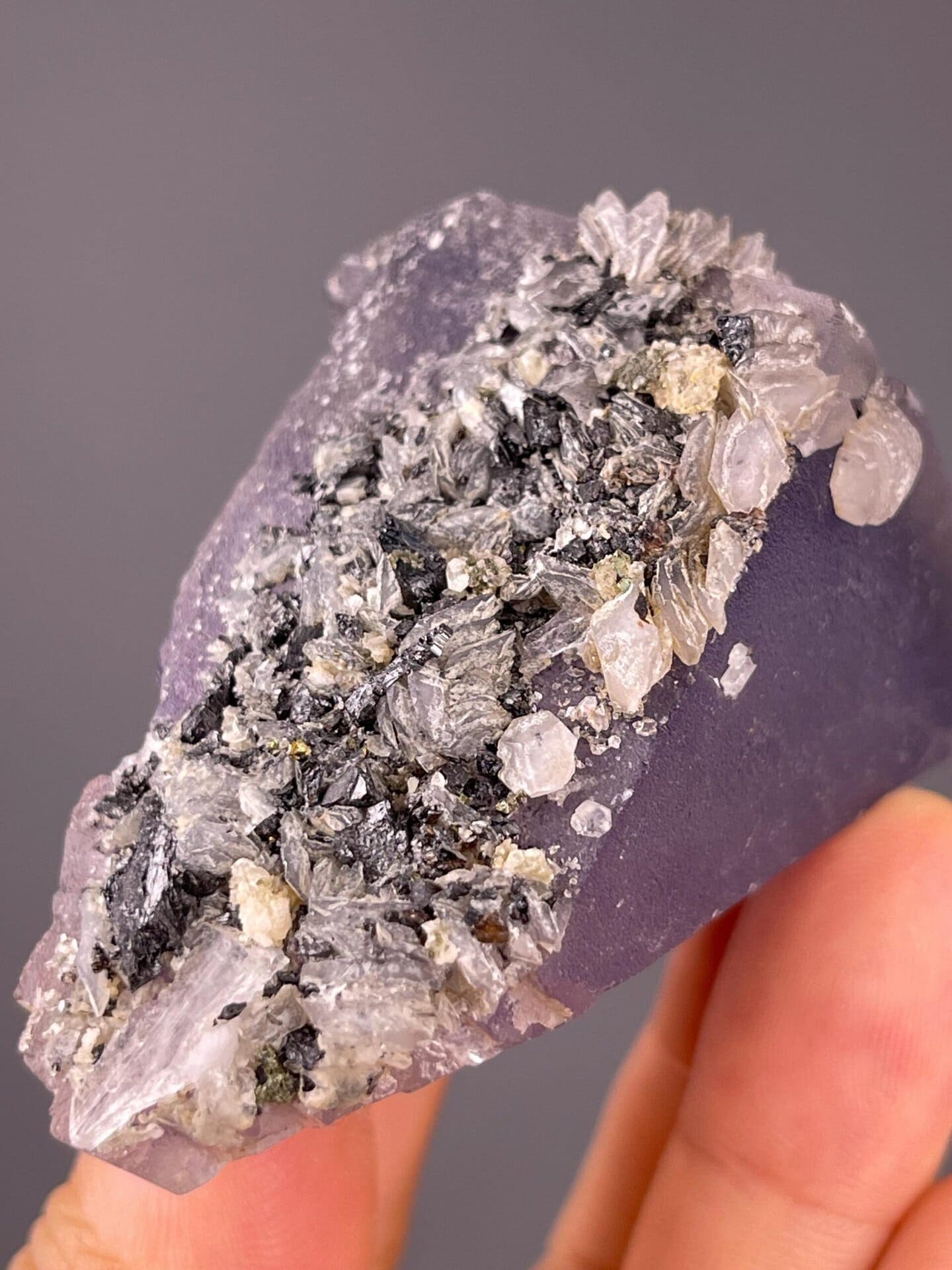 Light through purple fluorite triangular crystal