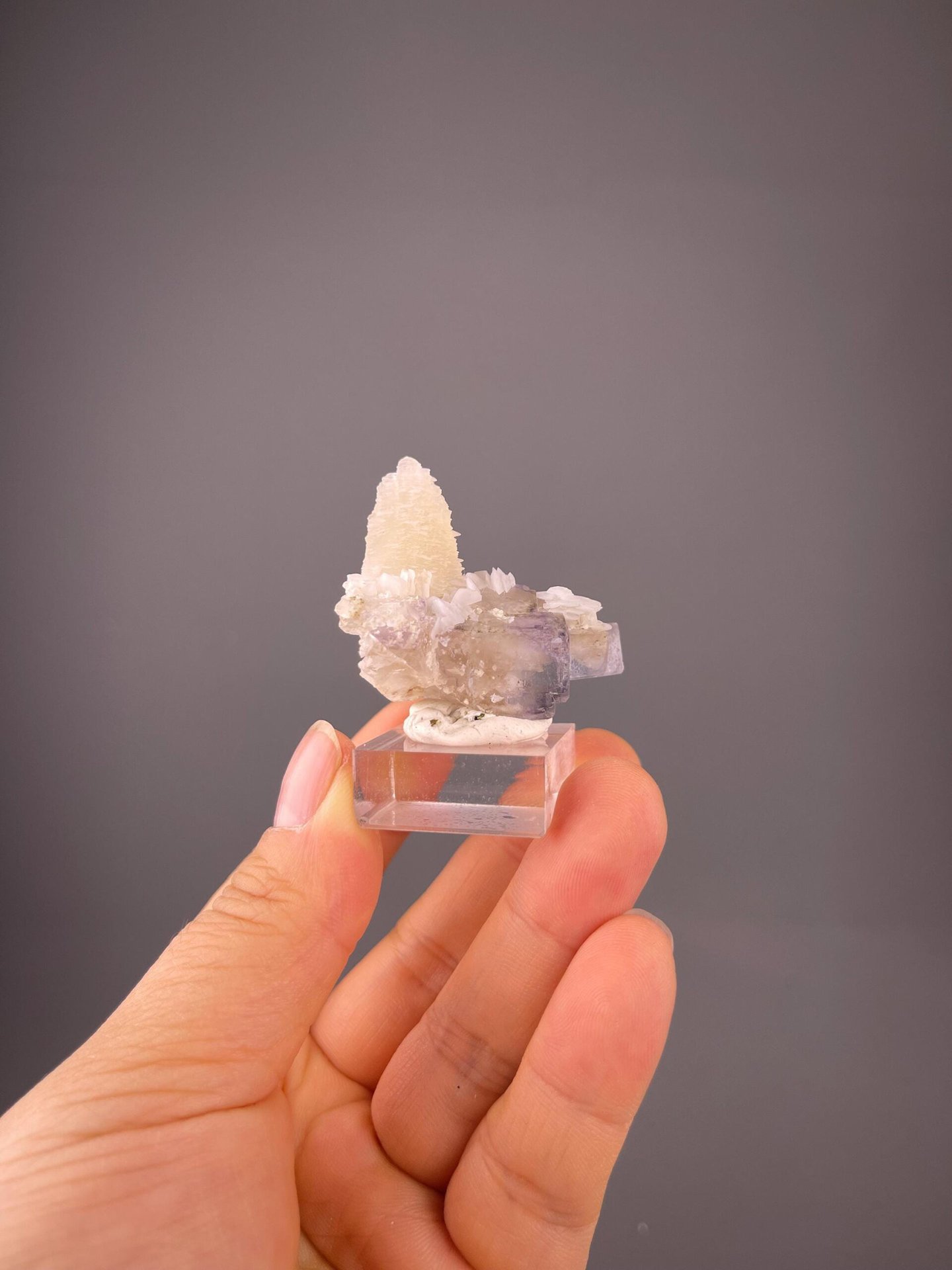 Delicate pagoda-shaped calcite on transparent fluorite matrix