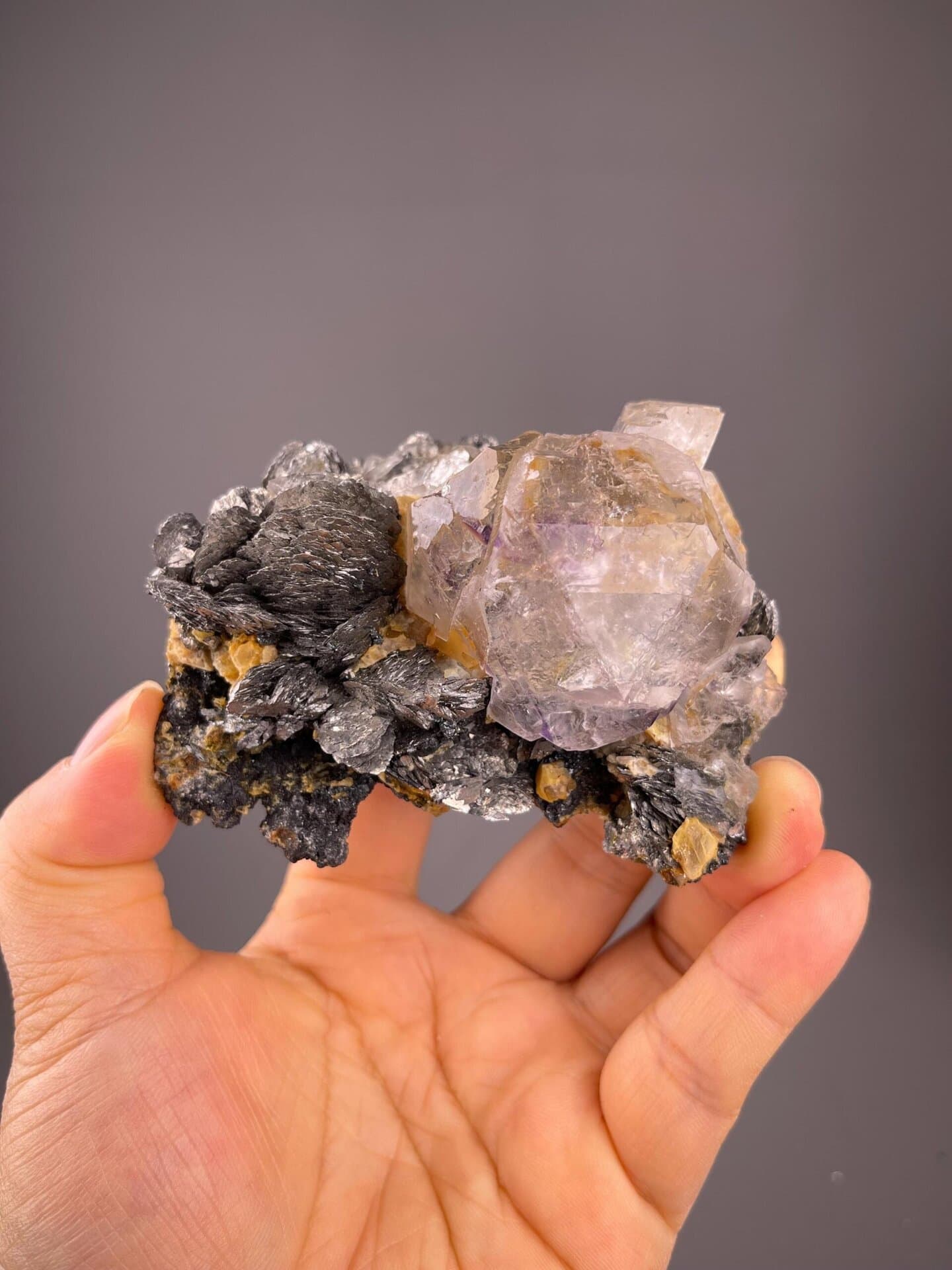 Transparent fluorite with purple phantom and marcasite on matrix