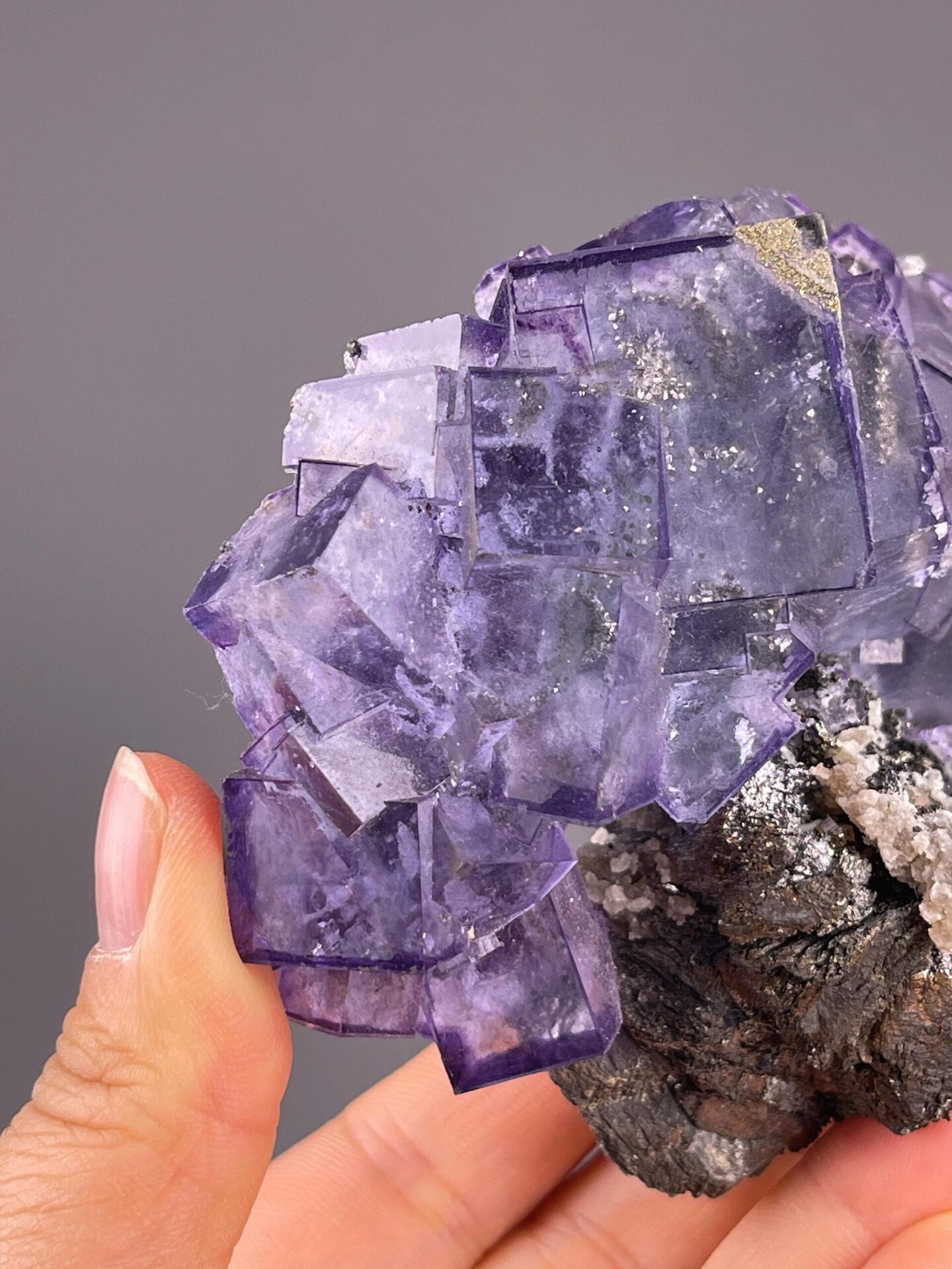 Purple fluorite cluster with phantom zones and metallic pyrite