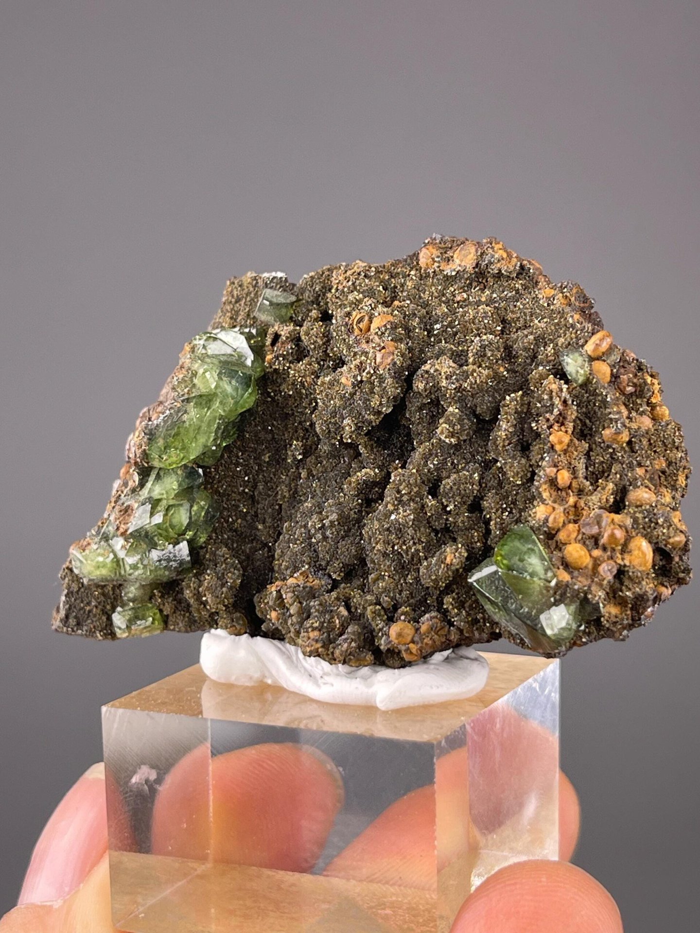 Vivid green raw grossular garnet crystals on contrasting matrix
