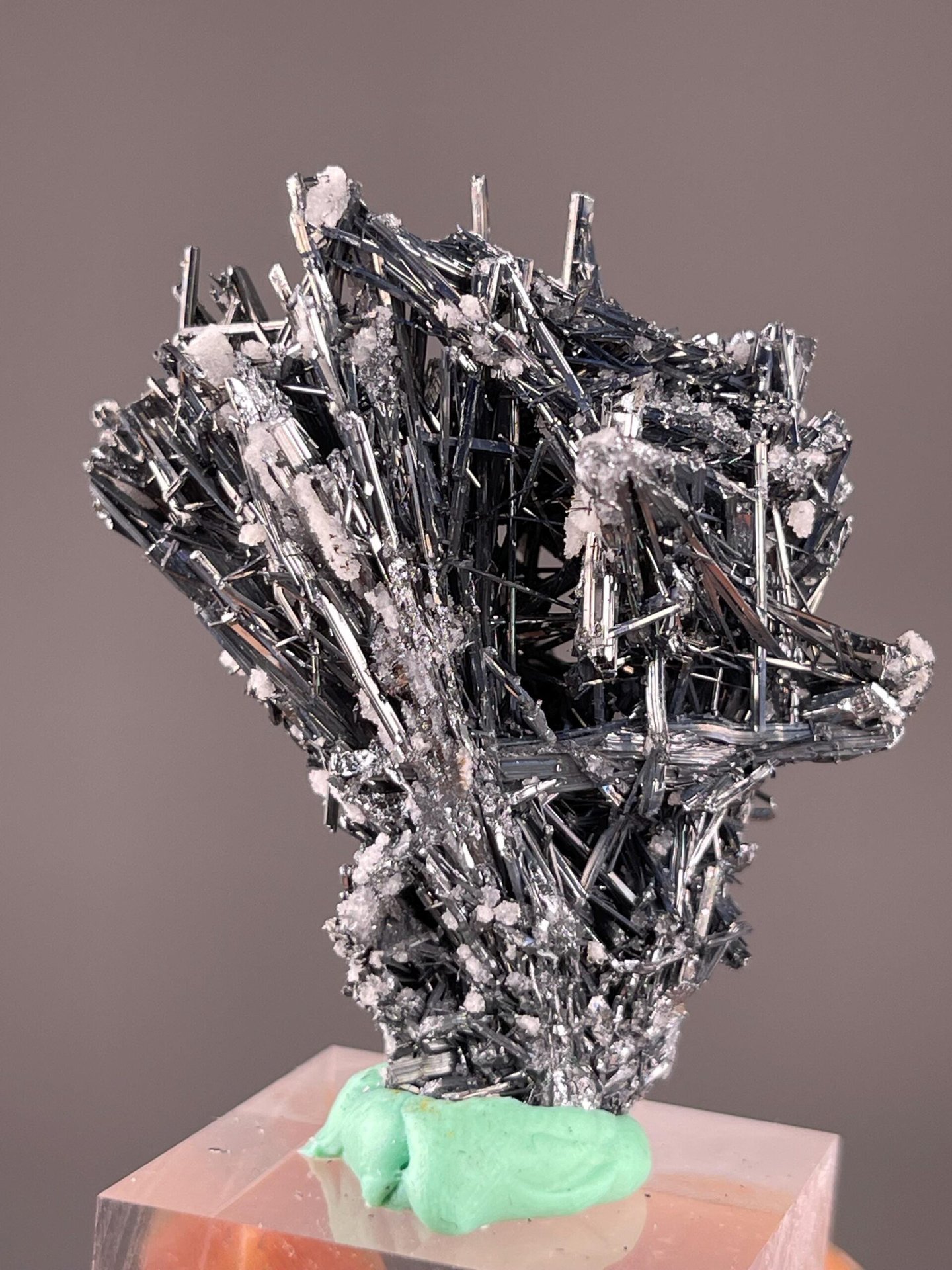 Metallic luster stibnite with associated calcite crystals