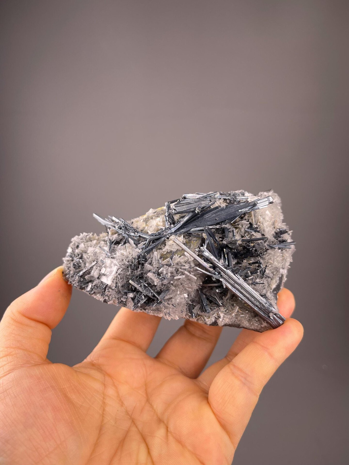 Dense metallic stibnite intergrown with clear barite crystals