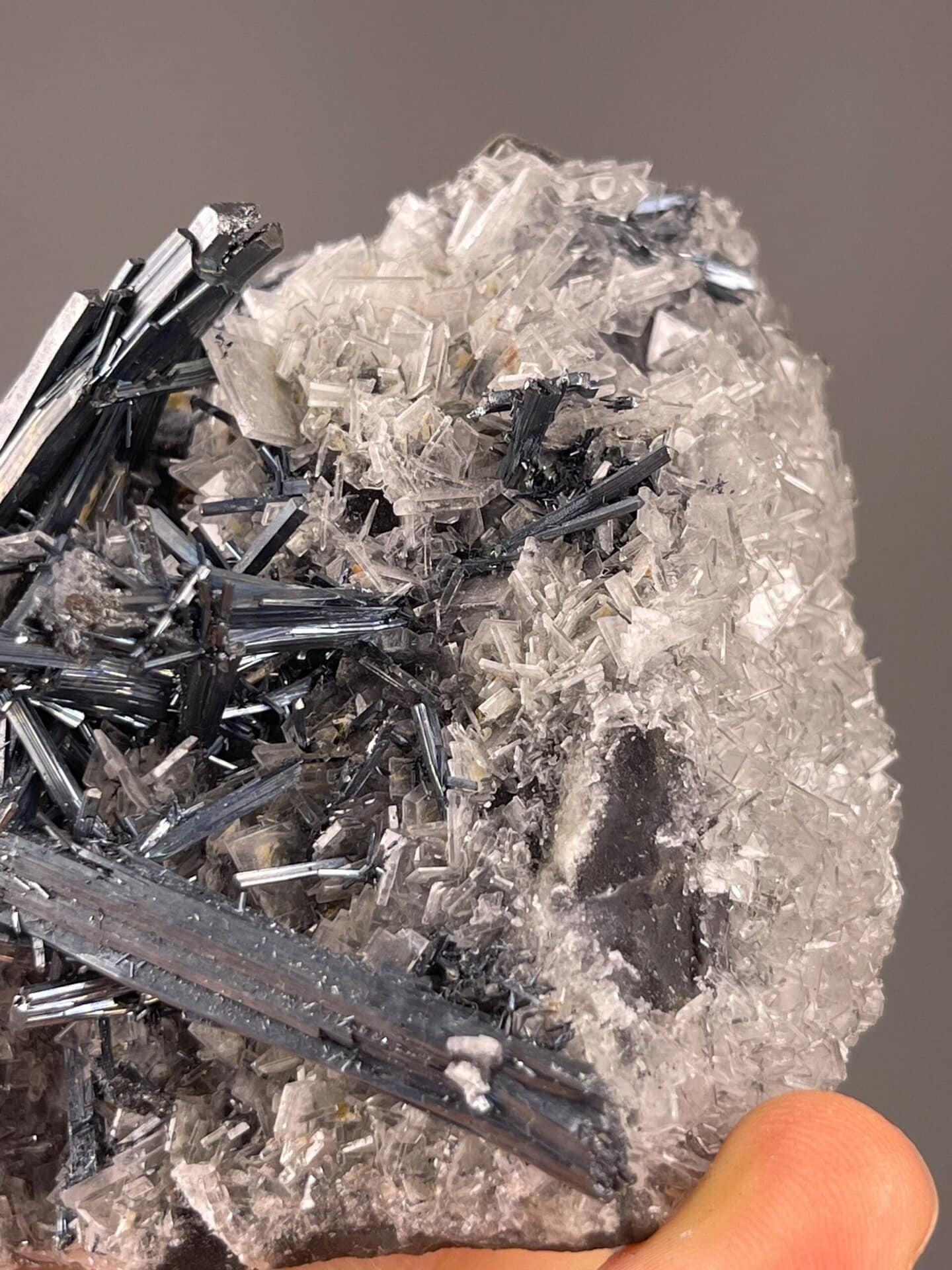Metallic stibnite crystal cluster with clear barite blades