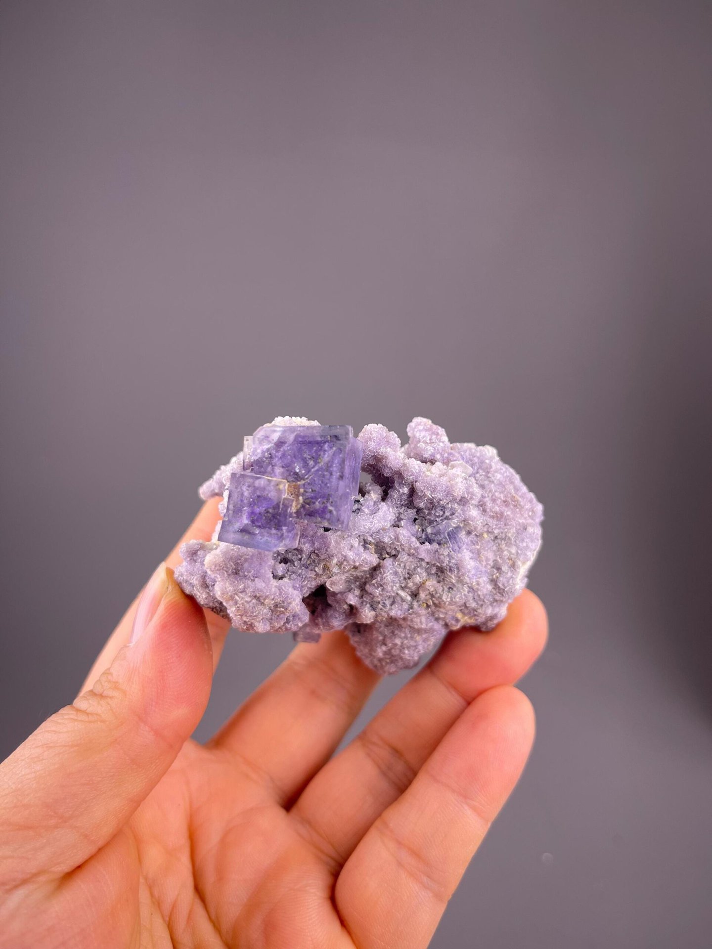 Purple fluorite cubic crystals with silver muscovite mica