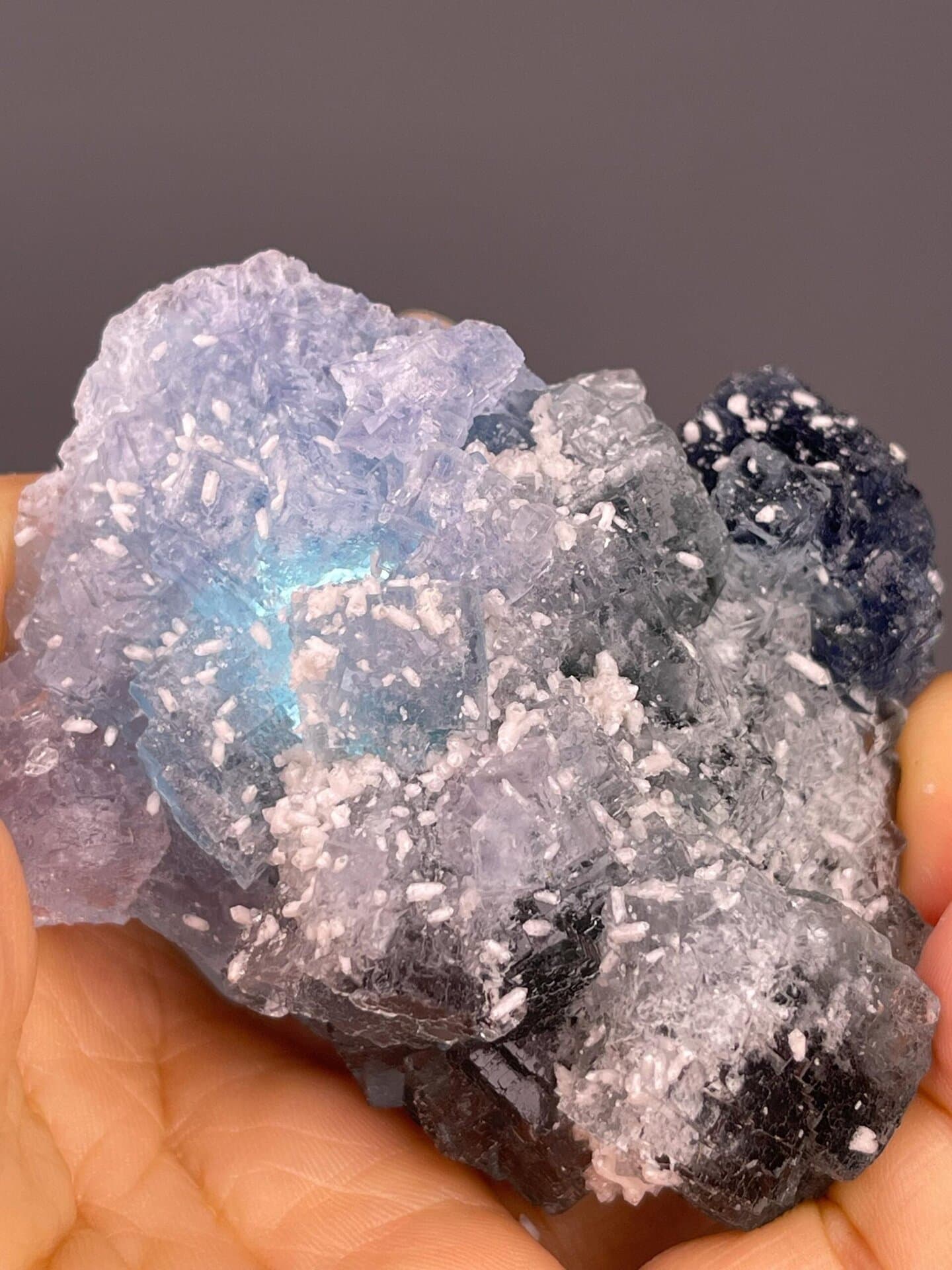 Fluorite with multiple color zones: deep blue, light blue, and green