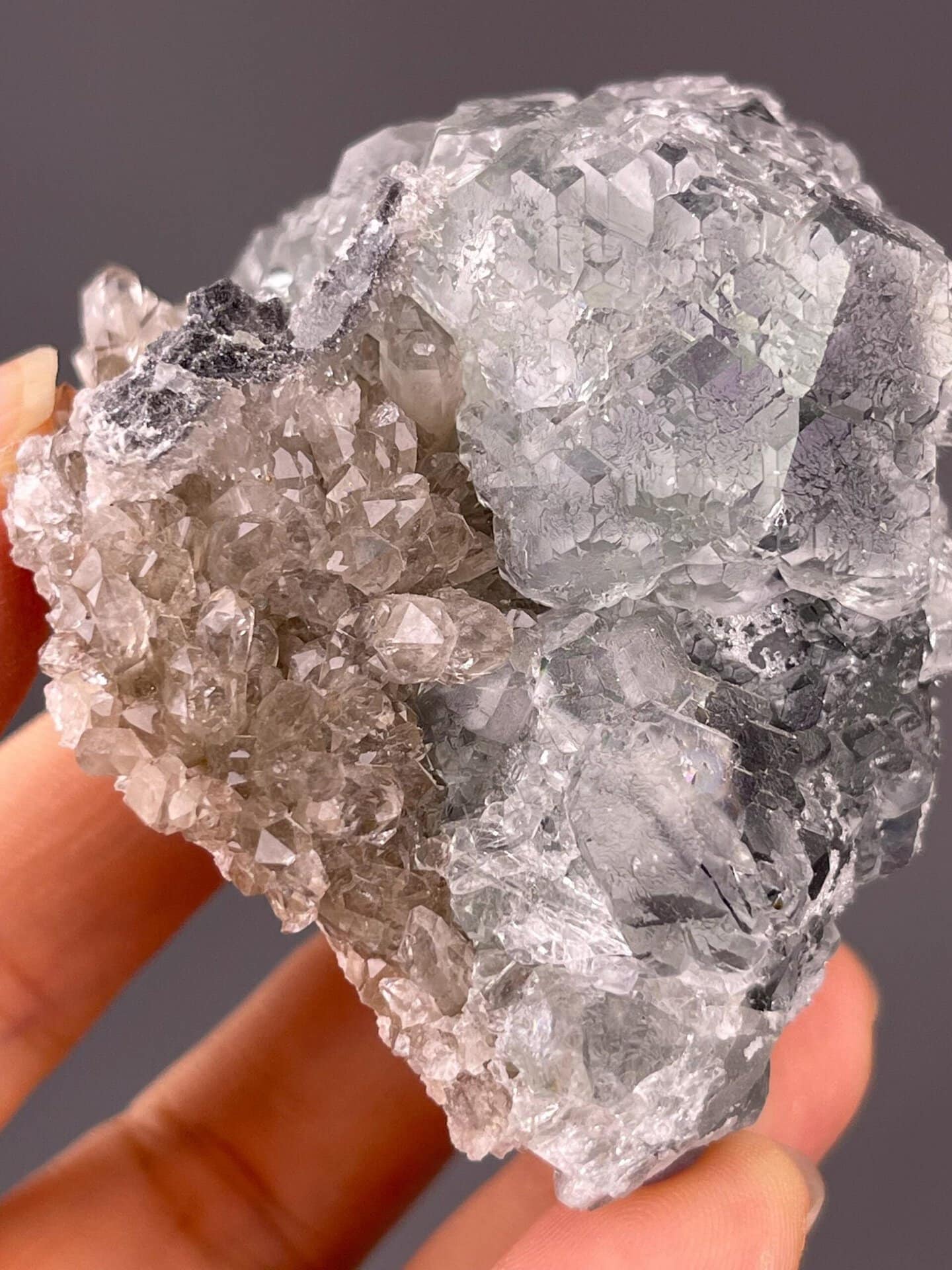 Translucent green fluorite spheres on crystalline quartz base