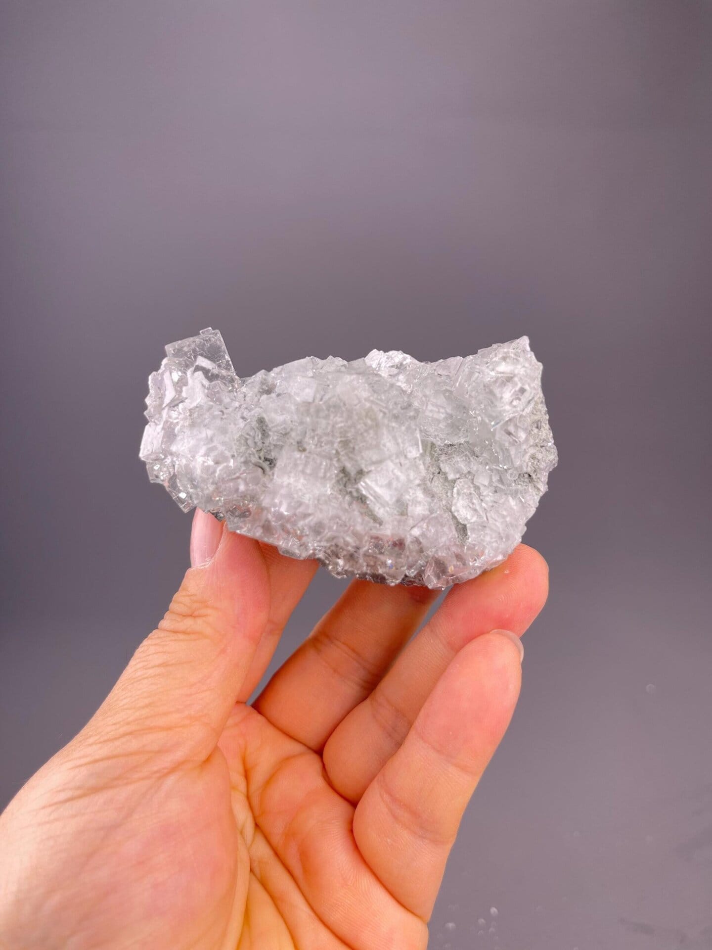 CaF₂ isometric fluorite with sharp cubic crystal faces, water-clear