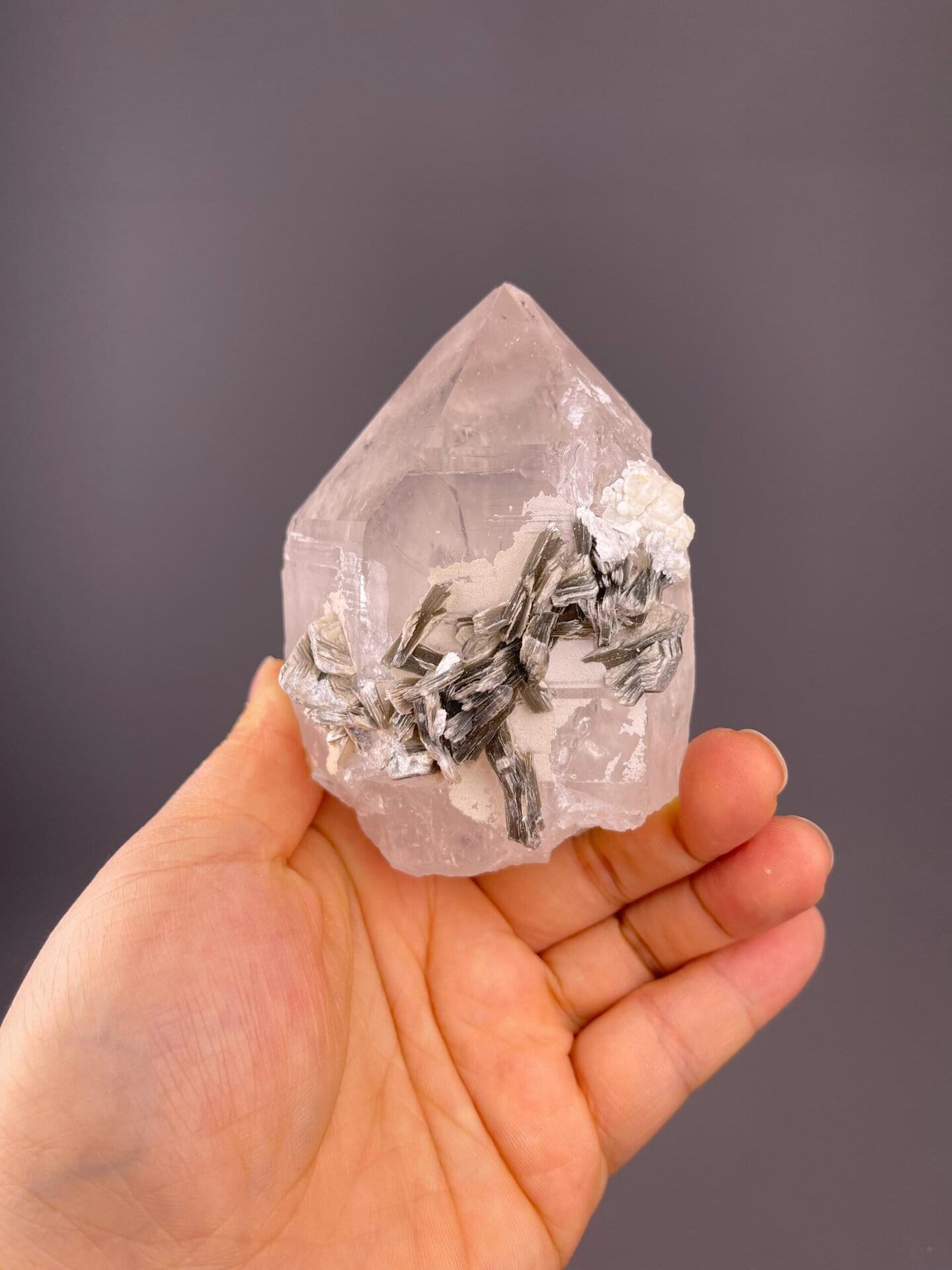 Clear quartz with silver-white mica blades and rosette forms
