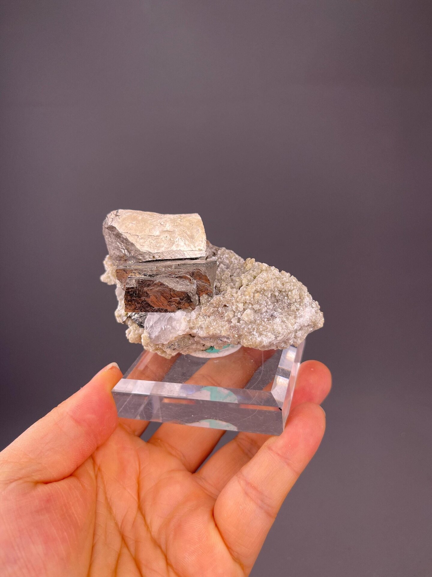 Brassy iridescent chalcopyrite covering white quartz matrix