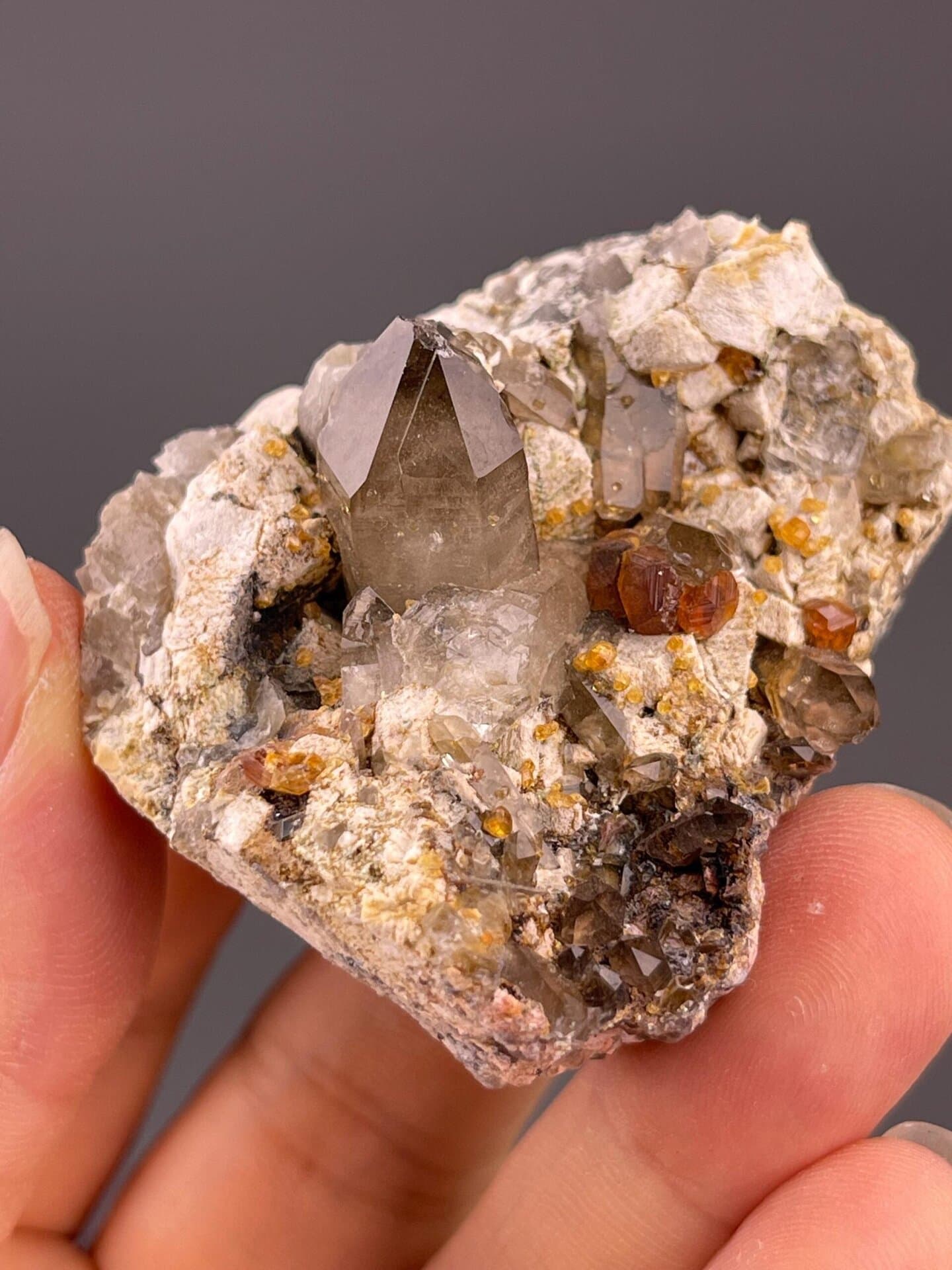 Smoky quartz with associated garnet crystals and dolomite