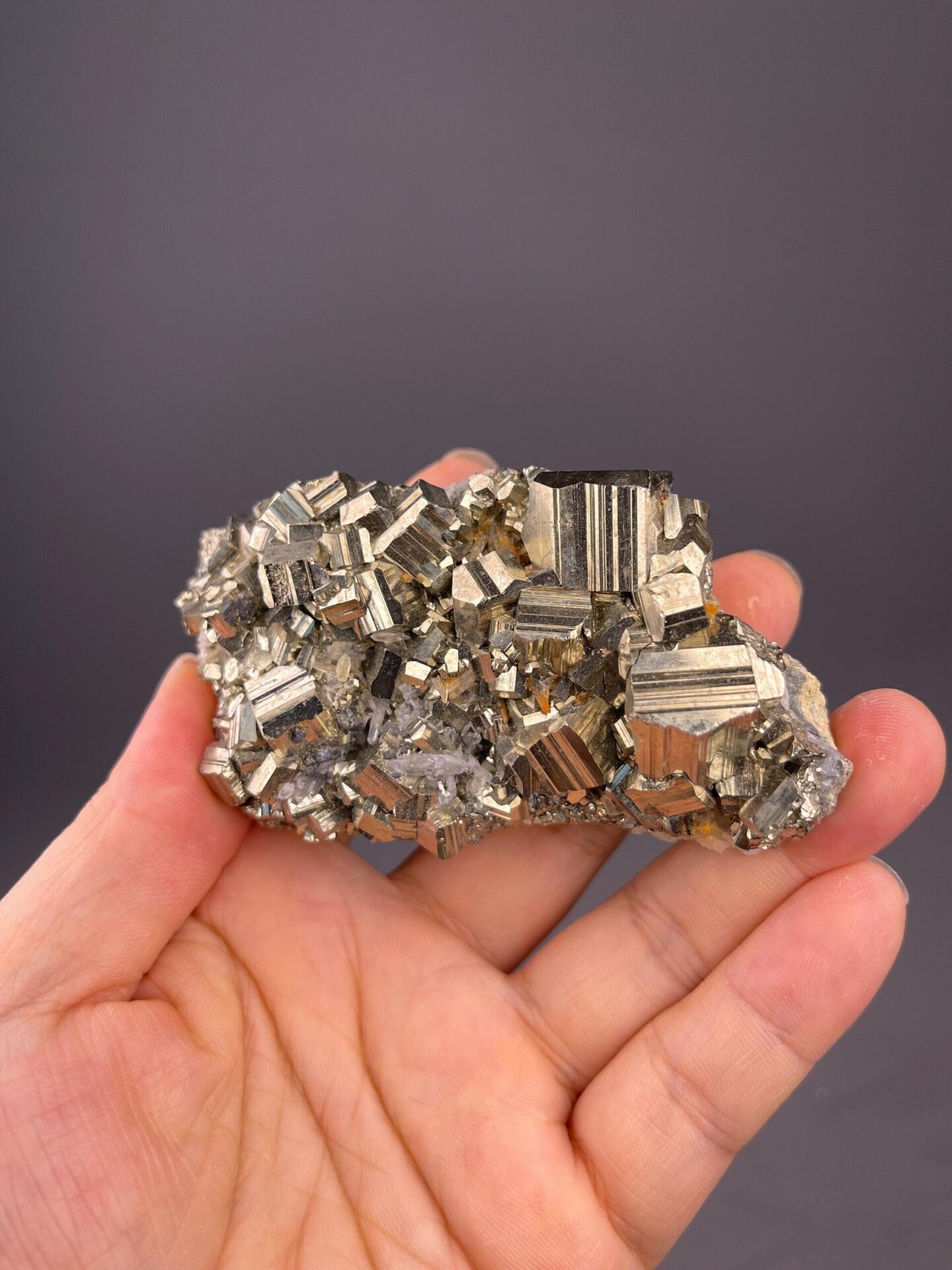Close-up of pyrite cube face showing mirror-like metallic surface