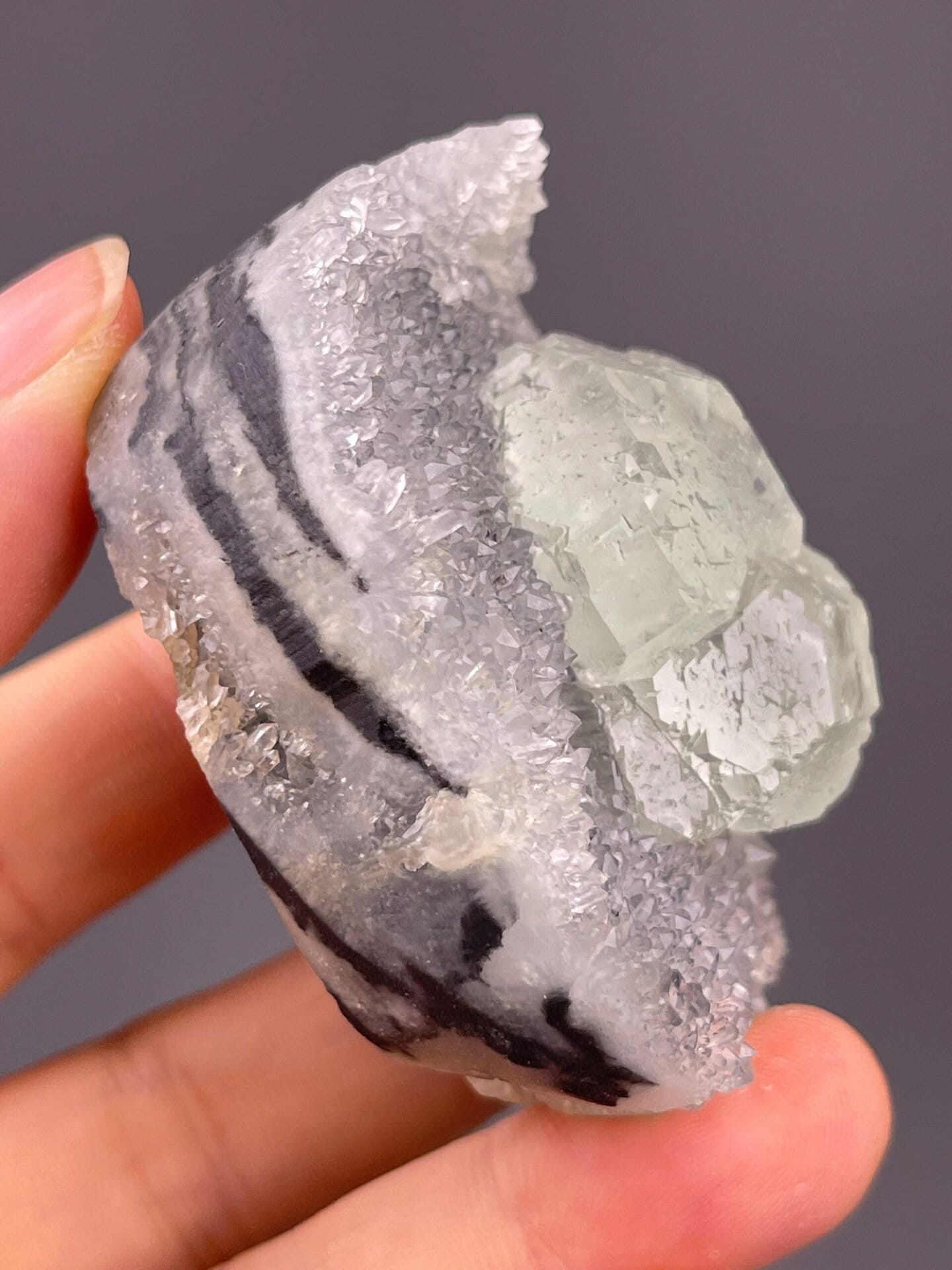 Angled view of twin fluorite crystals on quartz