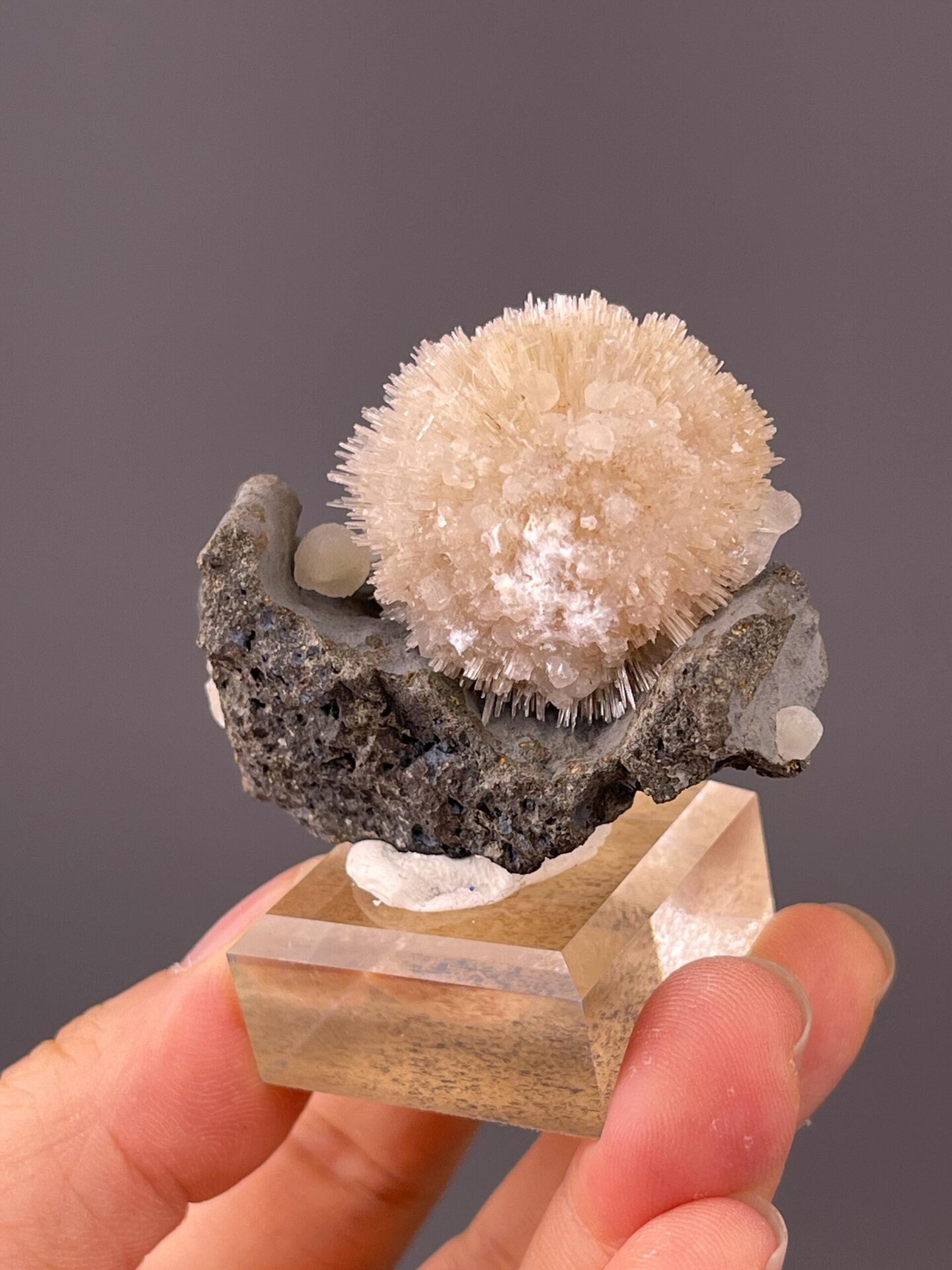Back view of Indian stilbite sphere on basalt