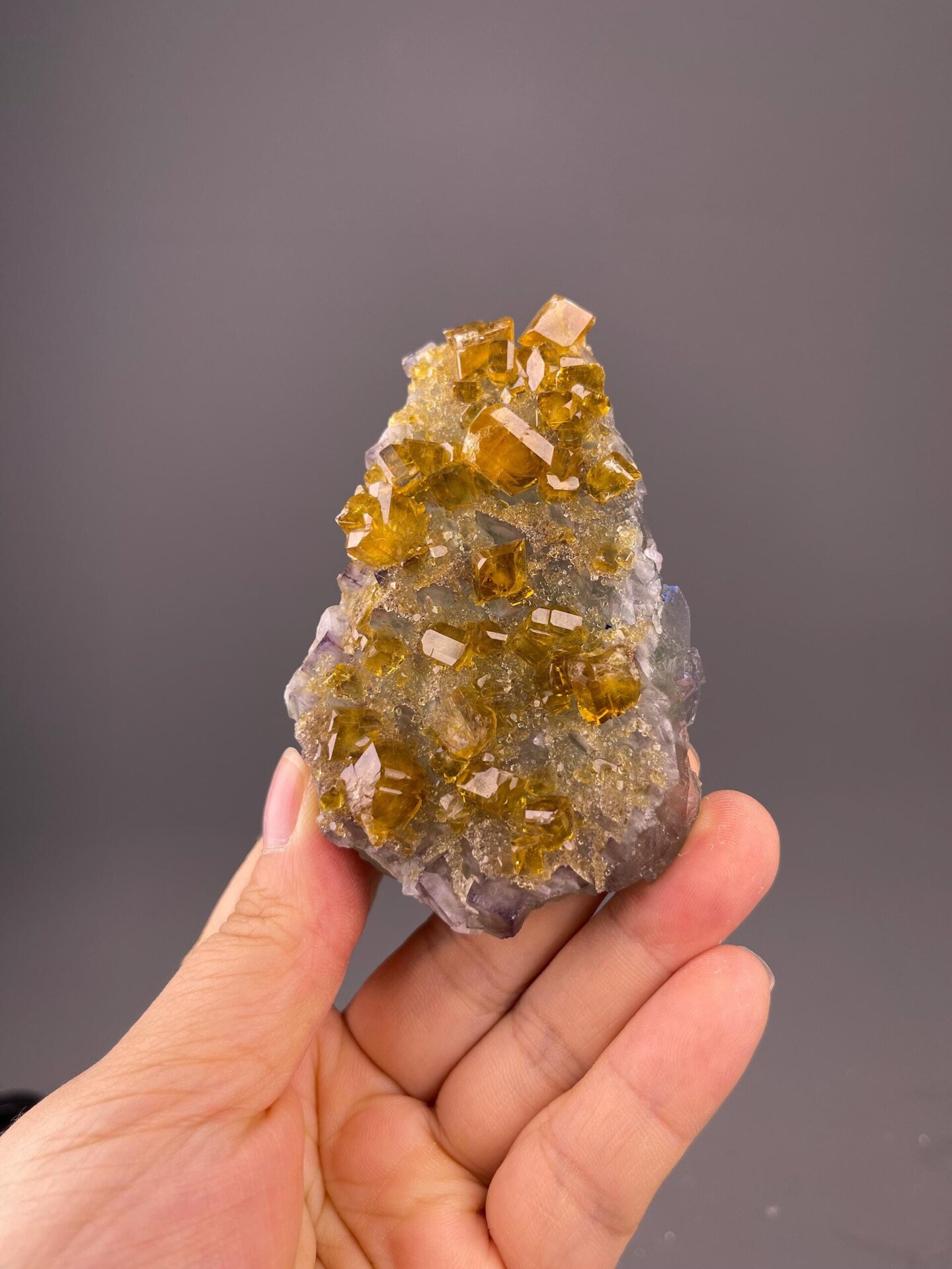 Front view of golden fluorite cluster on baryte matrix