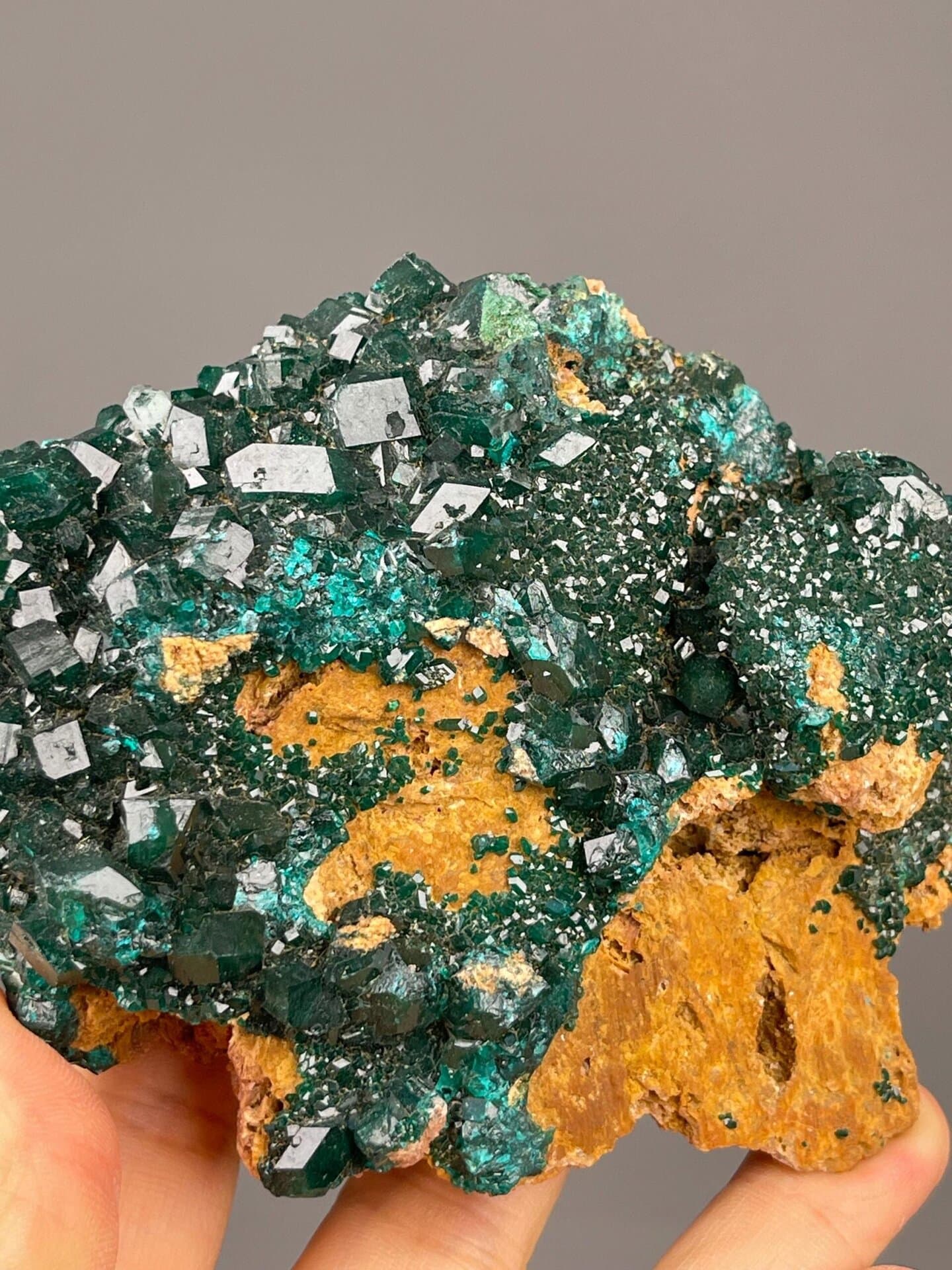 Front view of dioptase cluster showing vivid green crystals