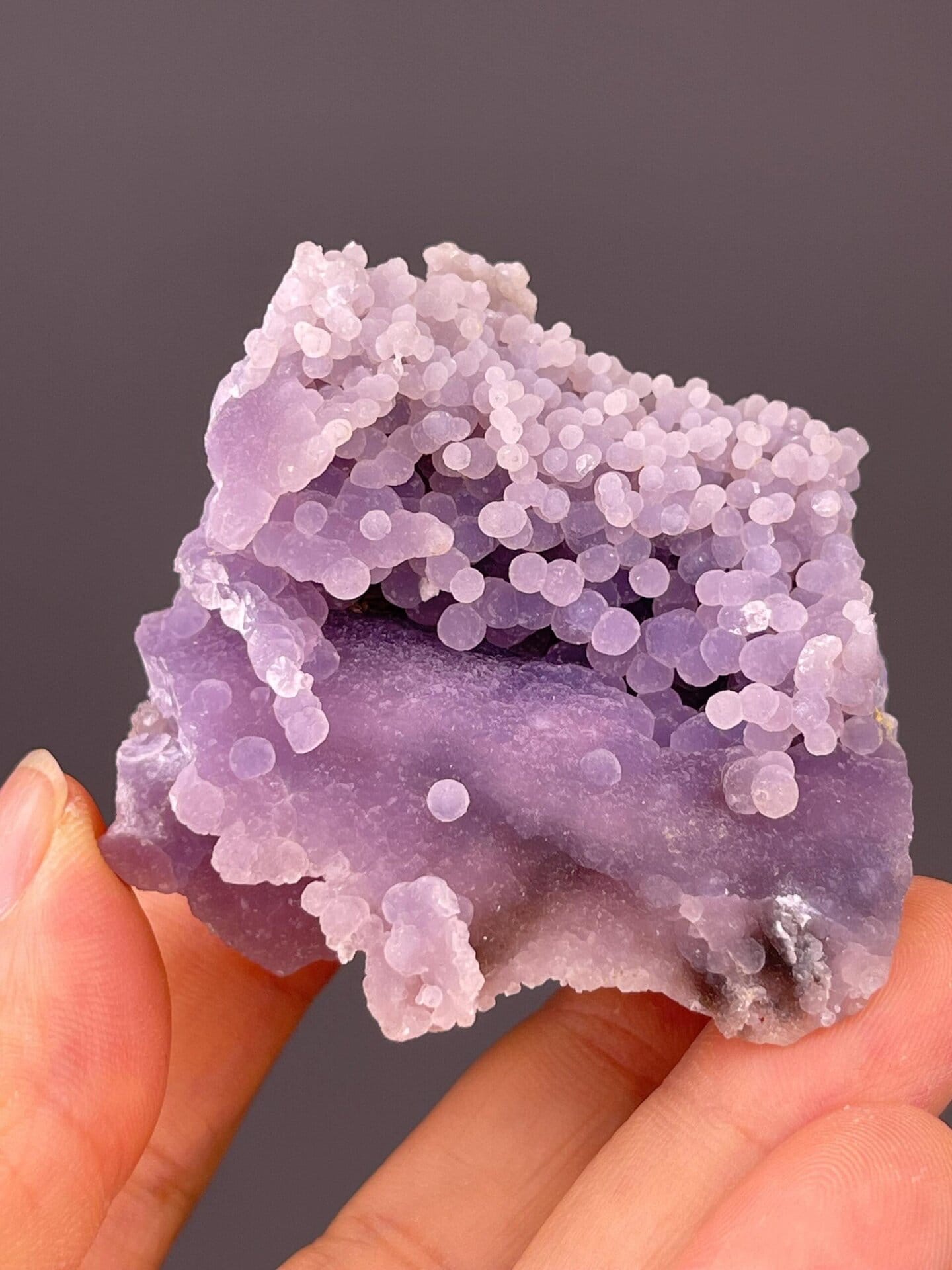 Angled view of grape agate highlighting rich purple colour