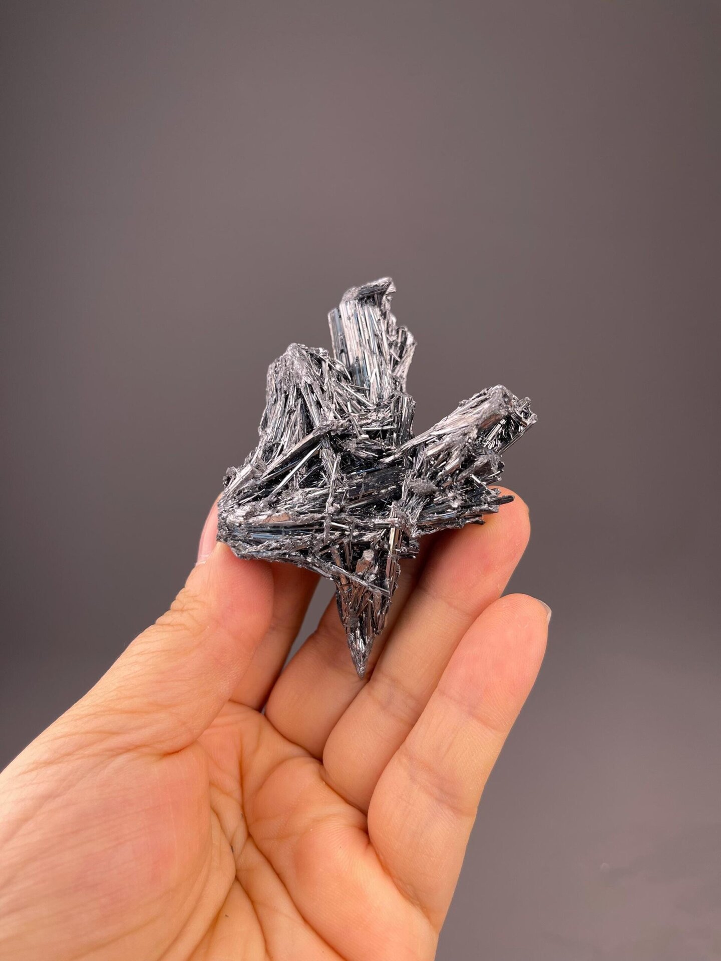 Close-up of acicular stibnite crystals showing metallic brilliance