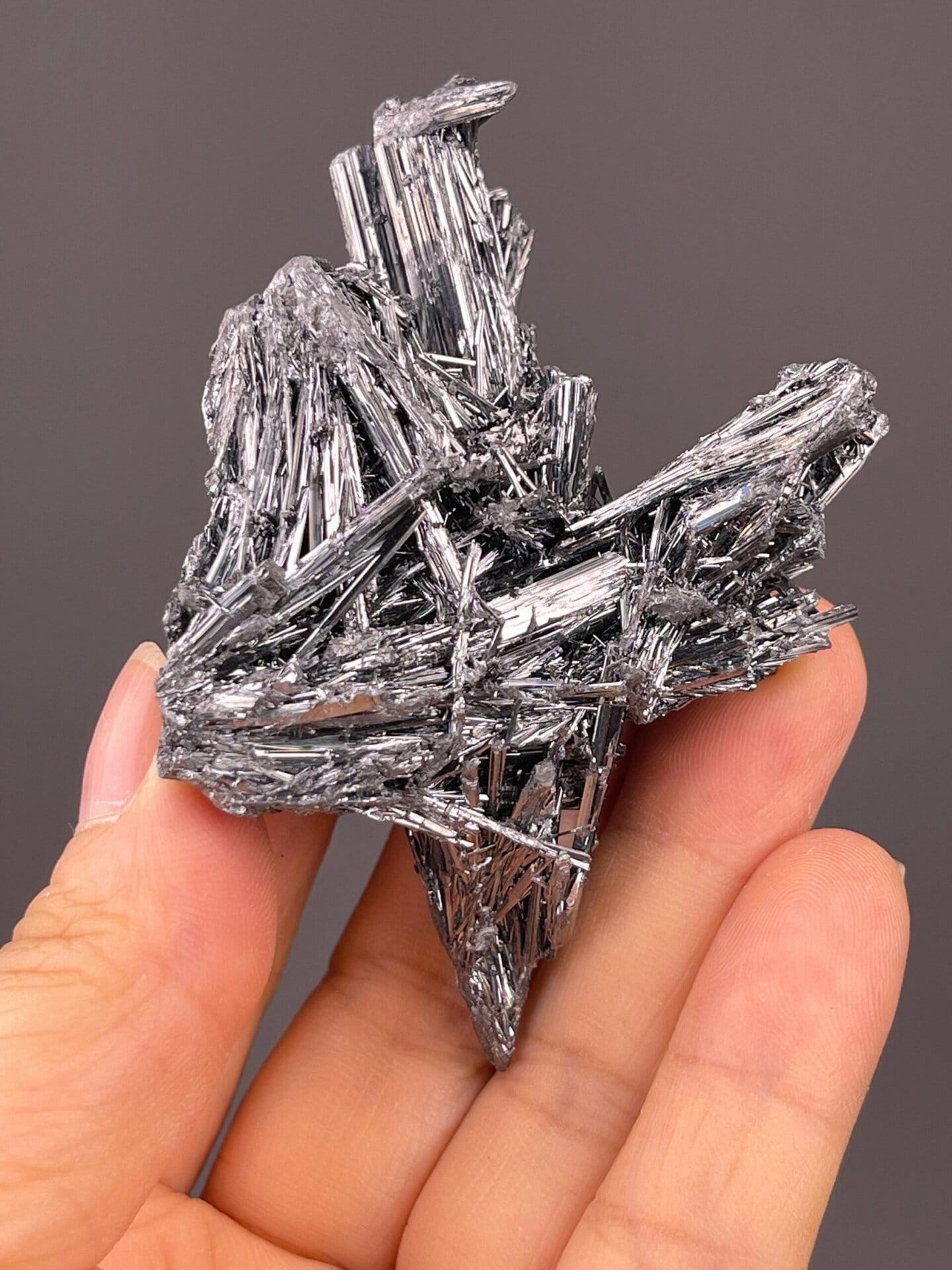 Angled view of stibnite cluster showing metallic sheen