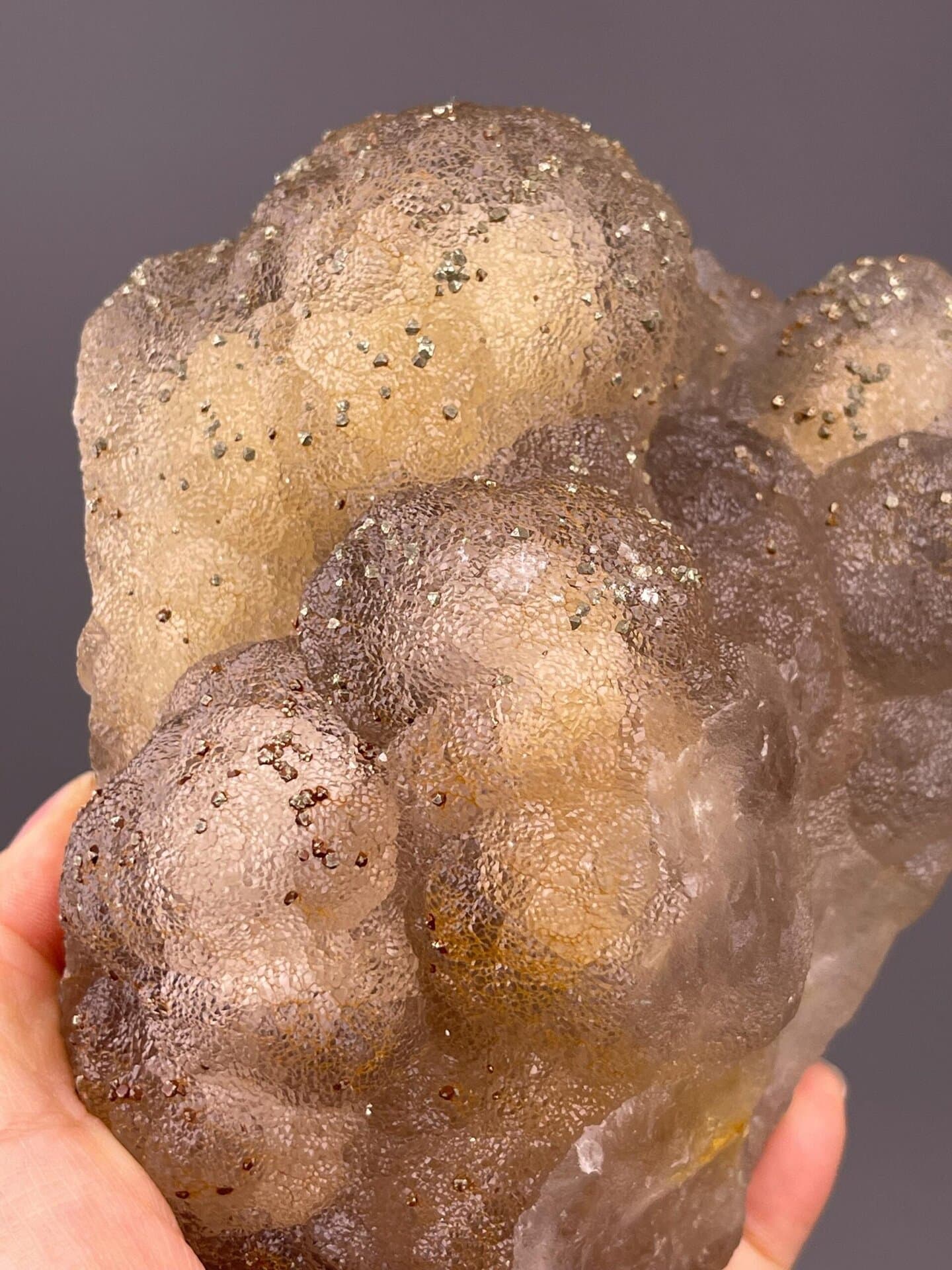 Close-up of pyrite crystals on yellow fluorite matrix