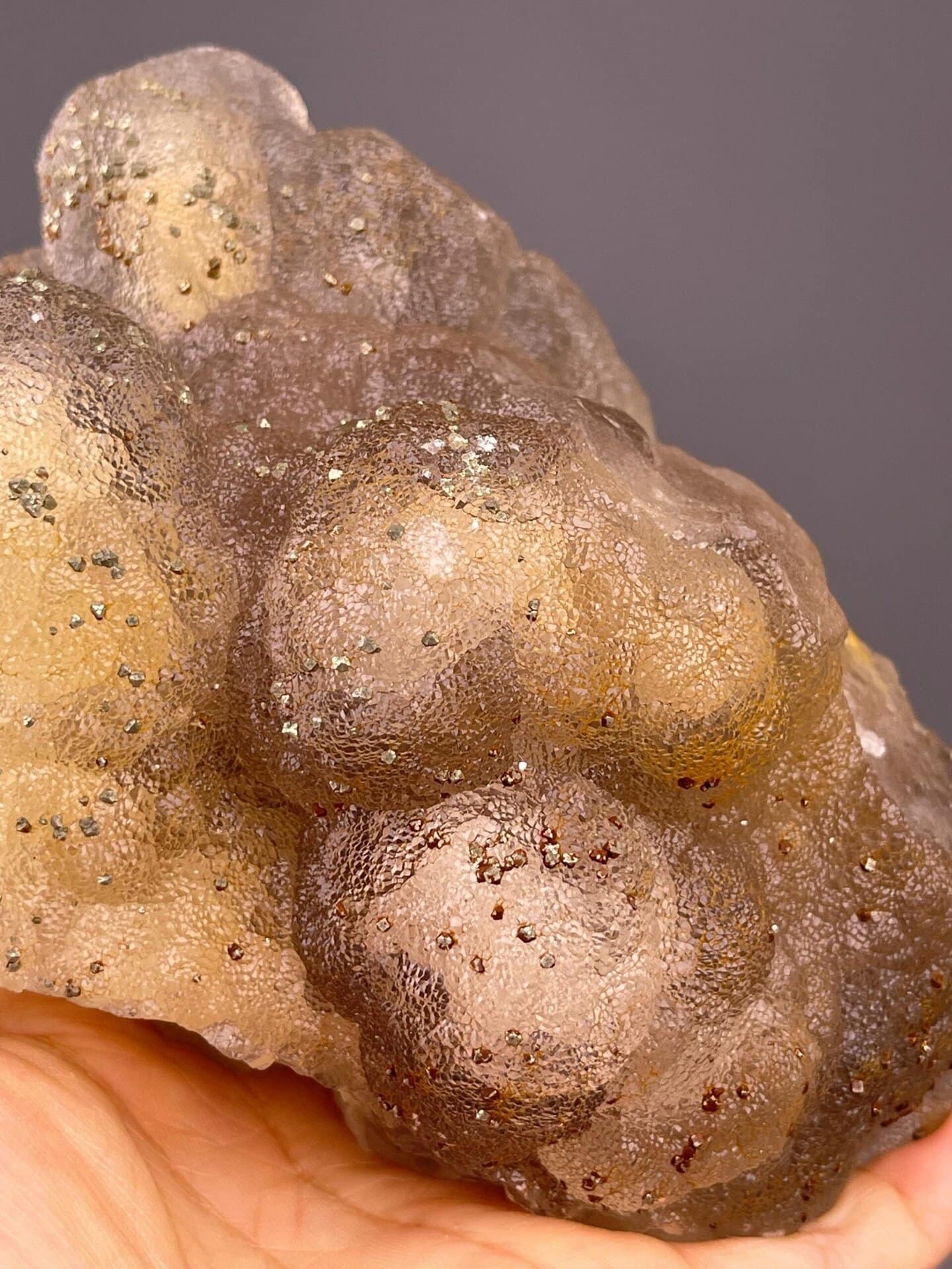 Close-up of golden-yellow botryoidal fluorite surface