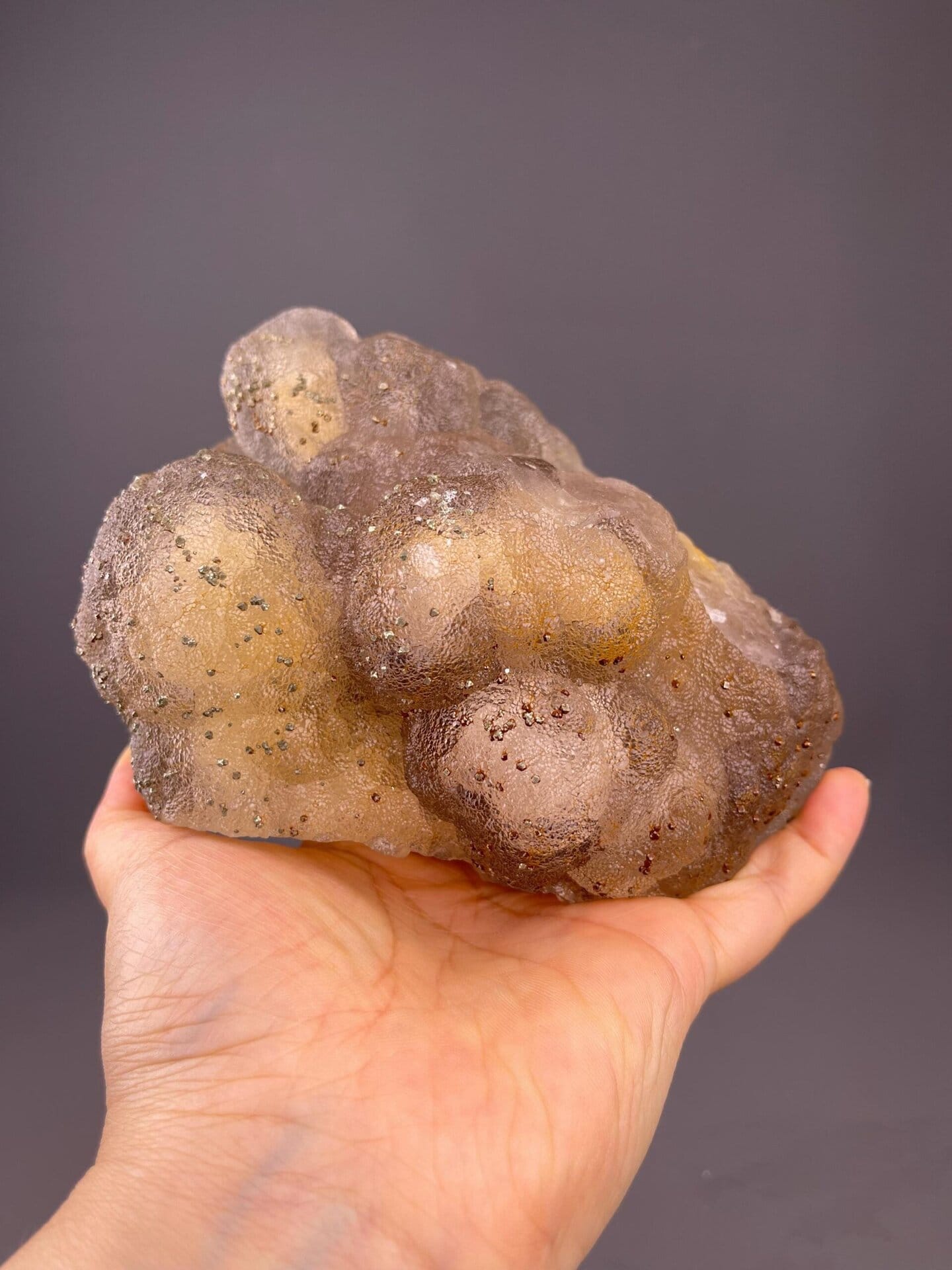 Angled view of large botryoidal yellow fluorite with pyrite