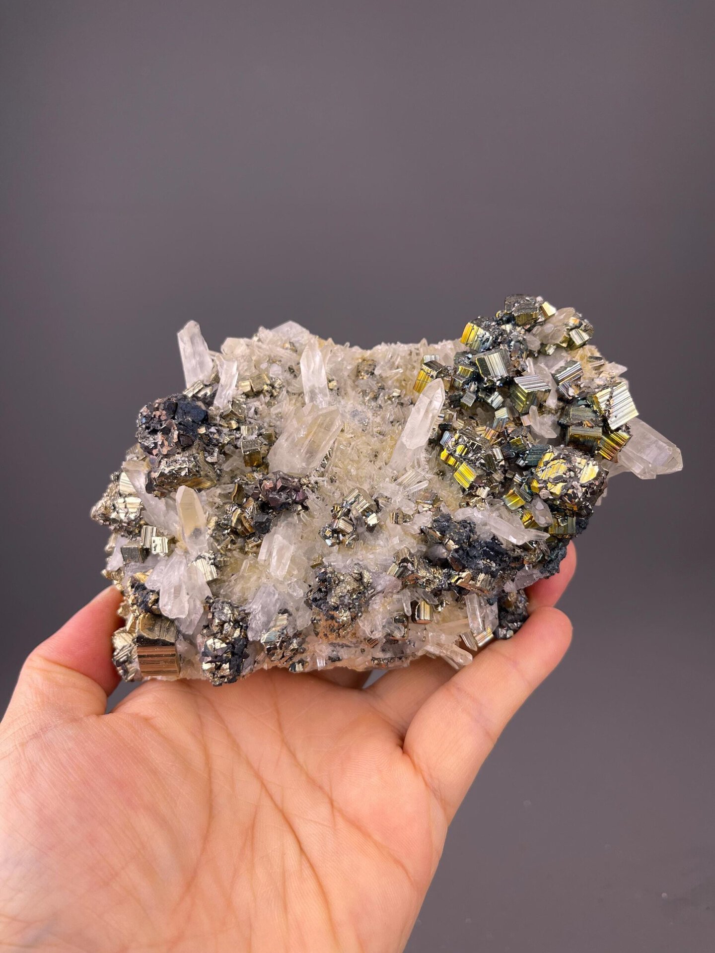 Front view of cubic pyrite cluster showing perfect cube faces