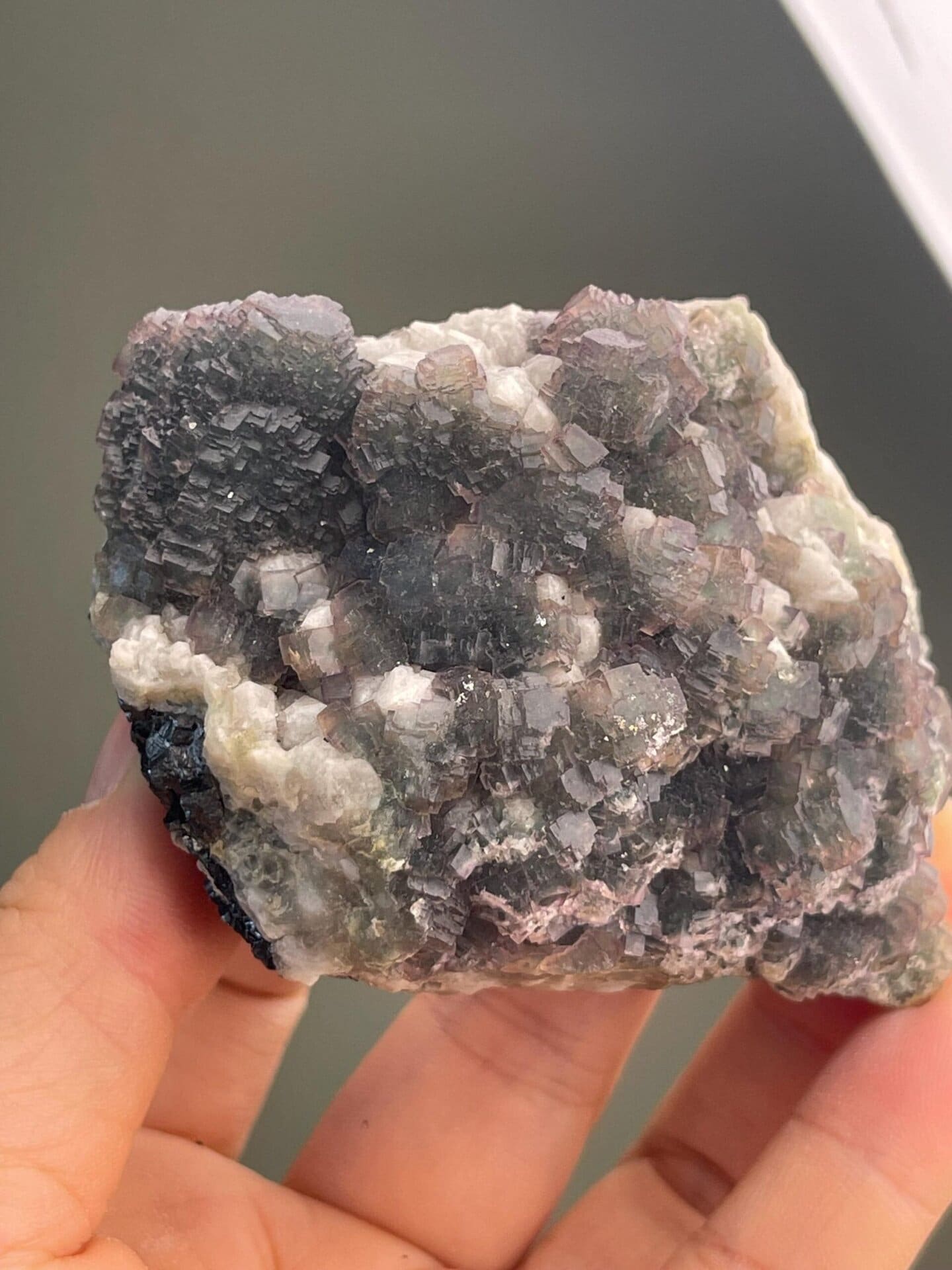 Two-tone fluorite showing green crystals with purple zoning