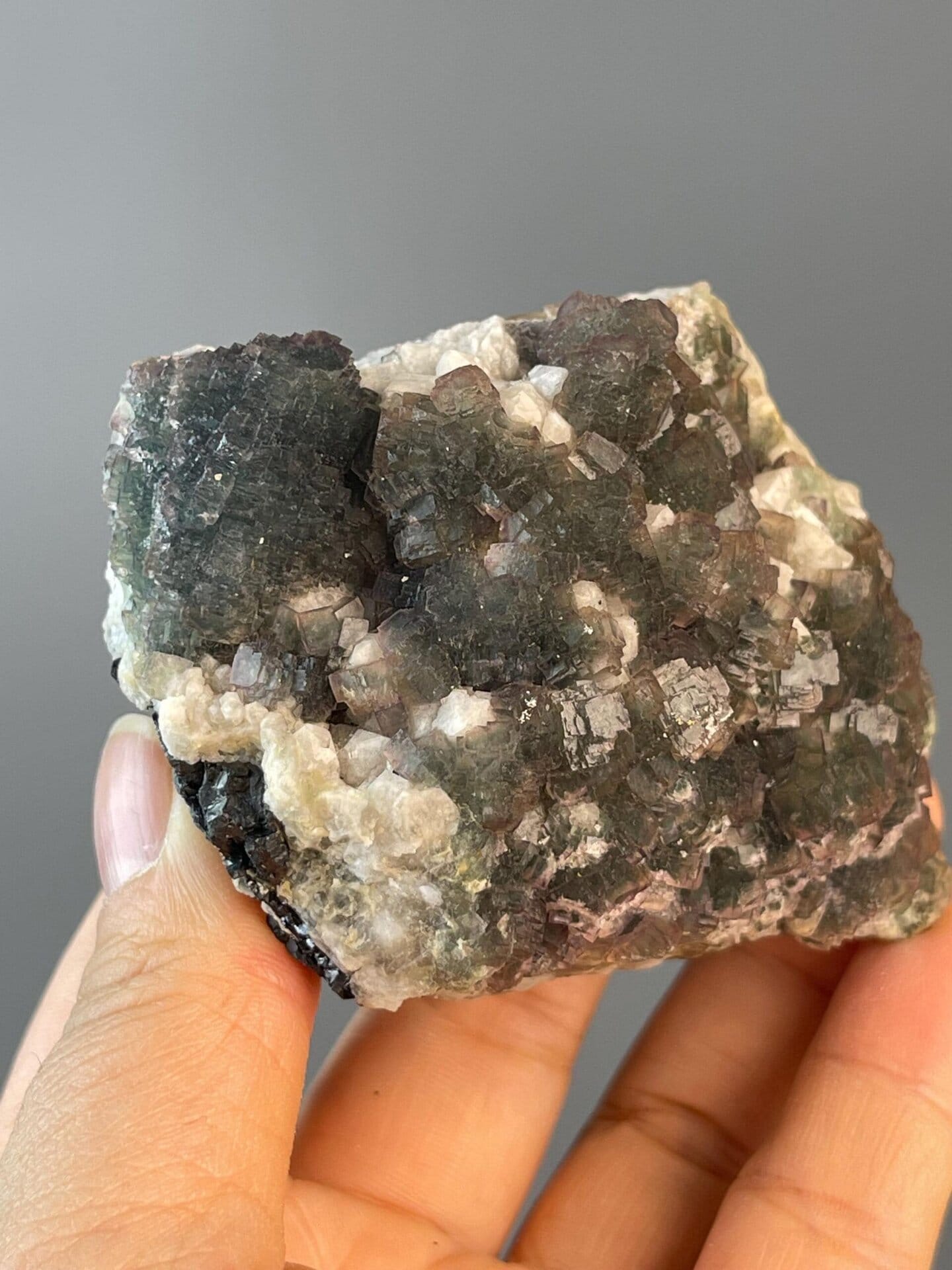 Purple trim accentuating stepped green fluorite faces