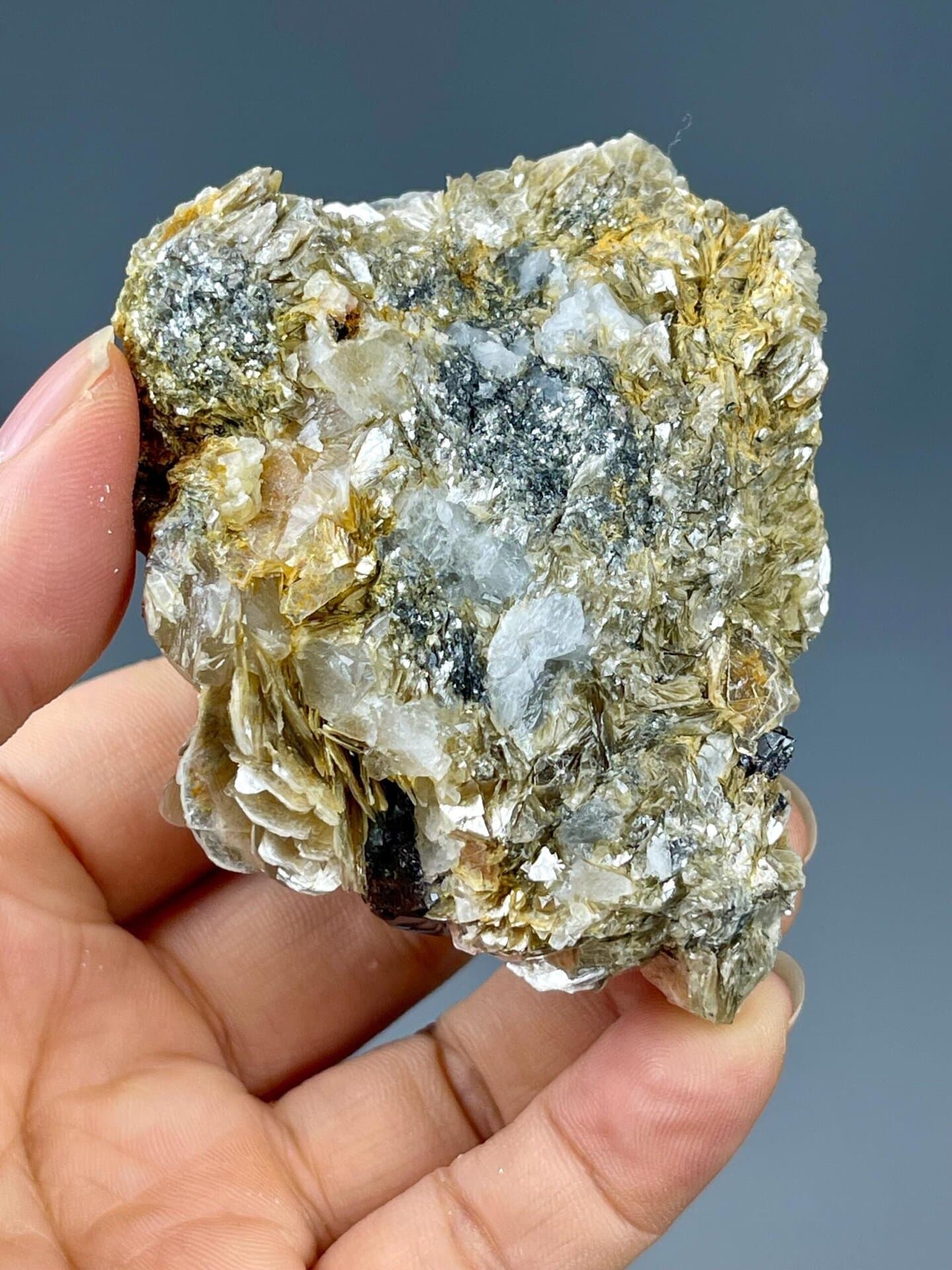 Cassiterite on muscovite mica showing adamantine luster