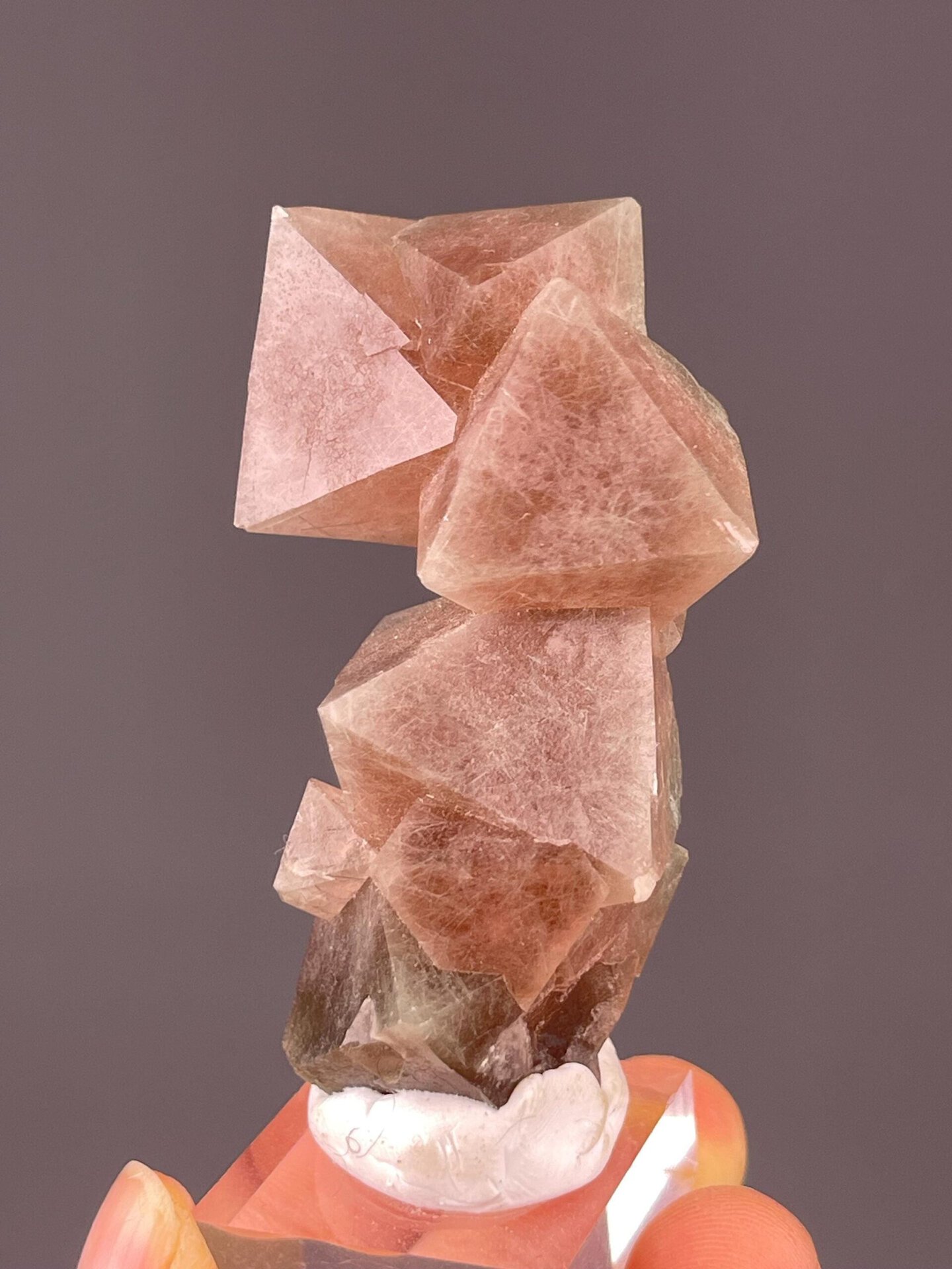 Close-up of red fluorite octahedral crystal faces