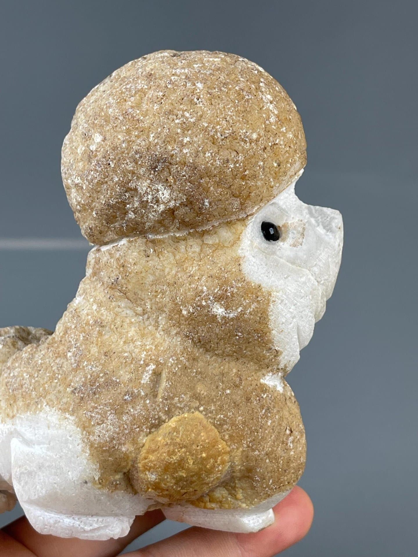 Naturalistic poodle form in hand-carved stone with onyx