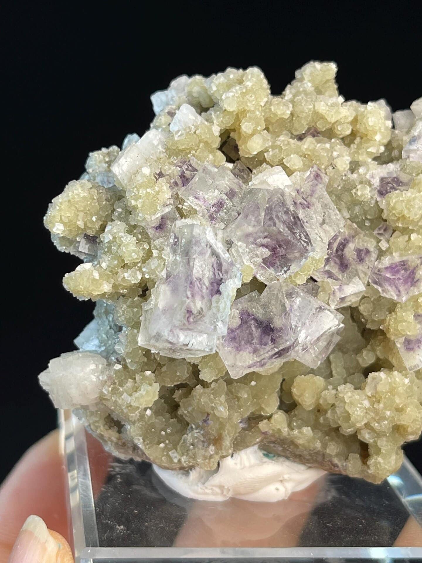 Green mineral base contrasting with purple phantom fluorite