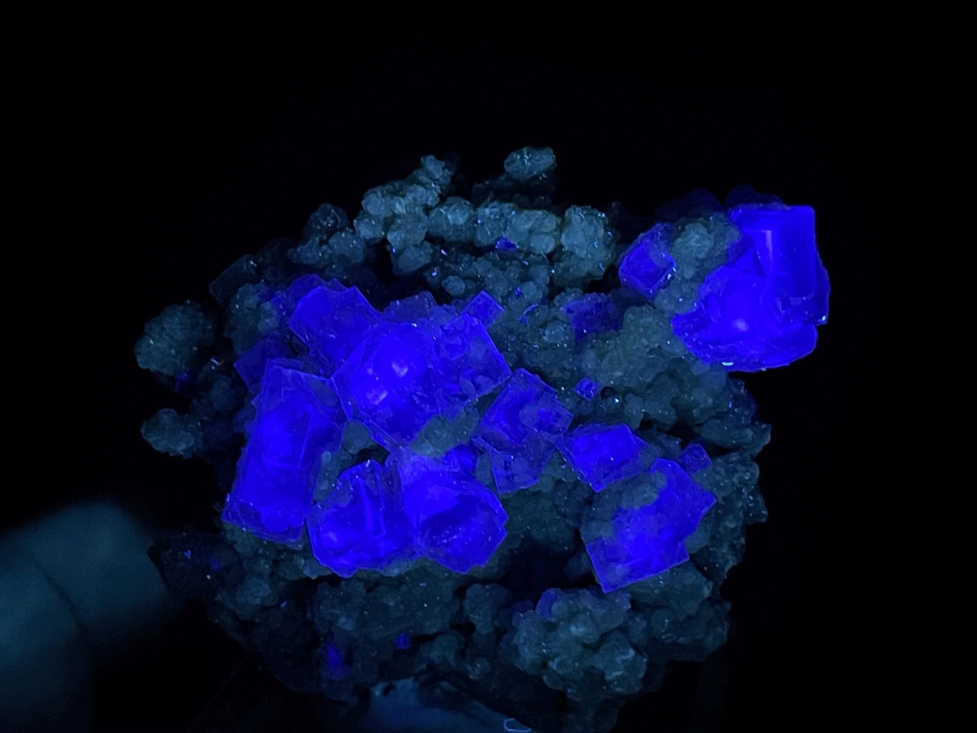 Purple phantom fluorite on green base displaying vitreous luster