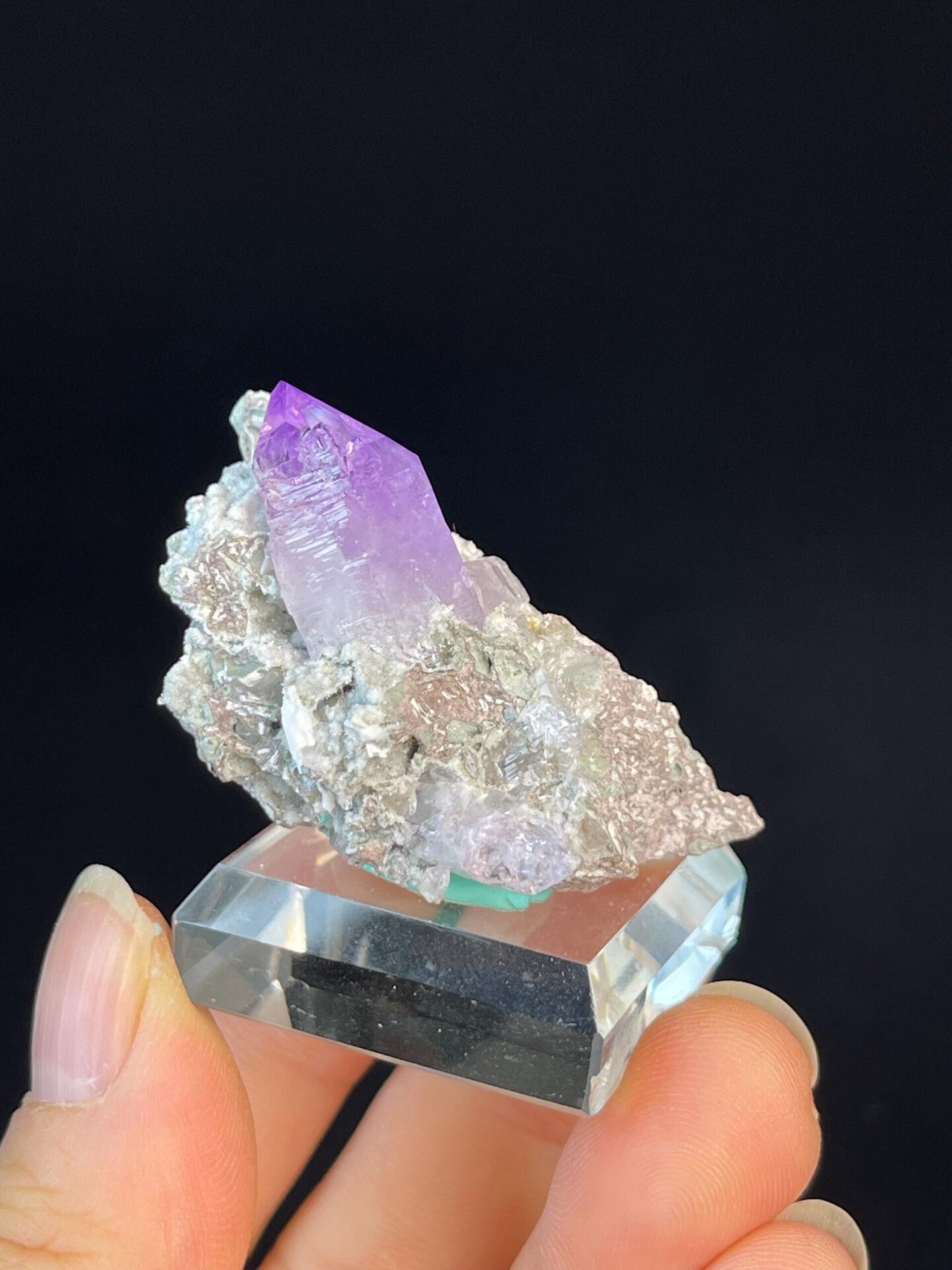 Vivid purple pillar amethyst quartz on rocky matrix